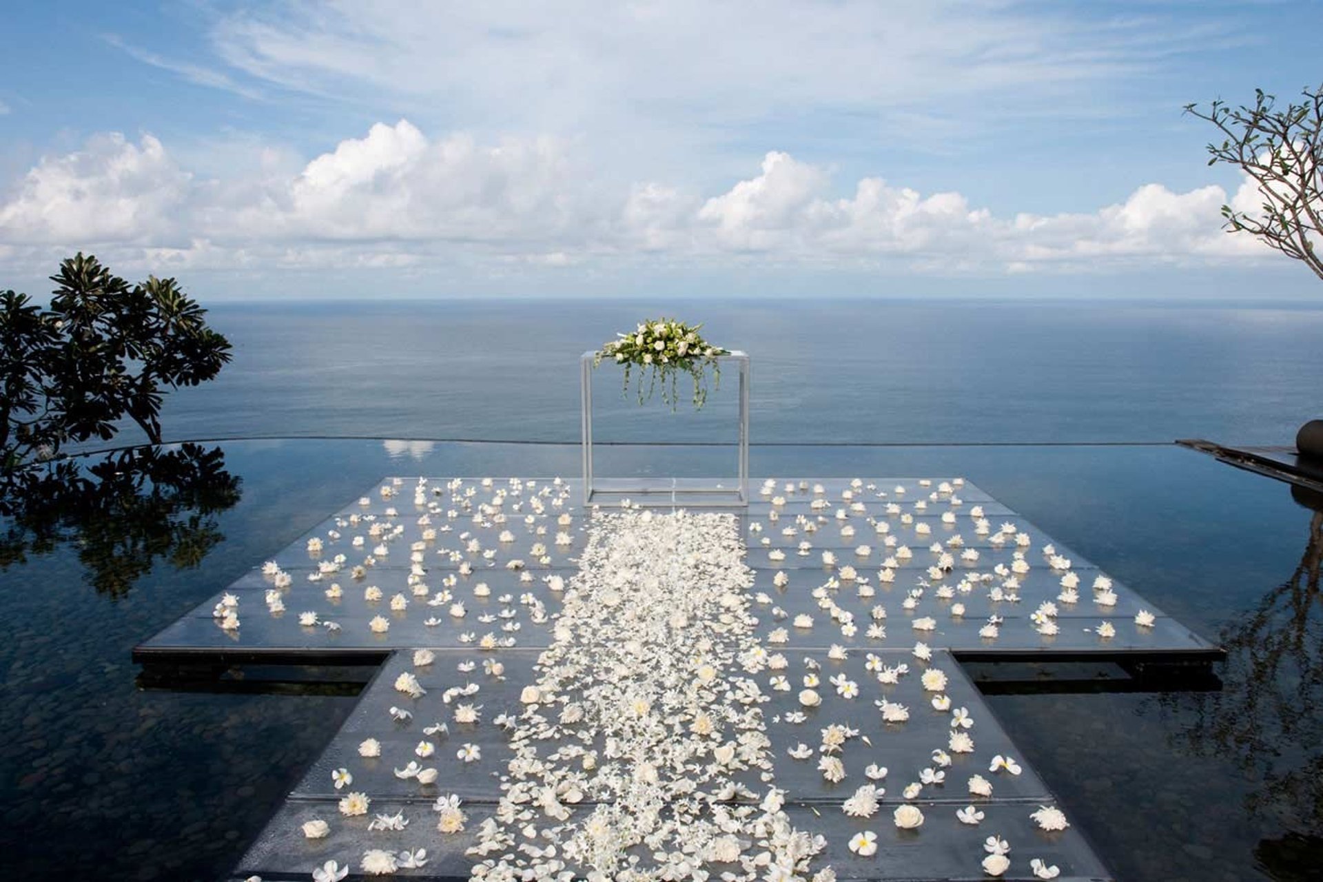Outdoor party setup with elegant table and decorations.