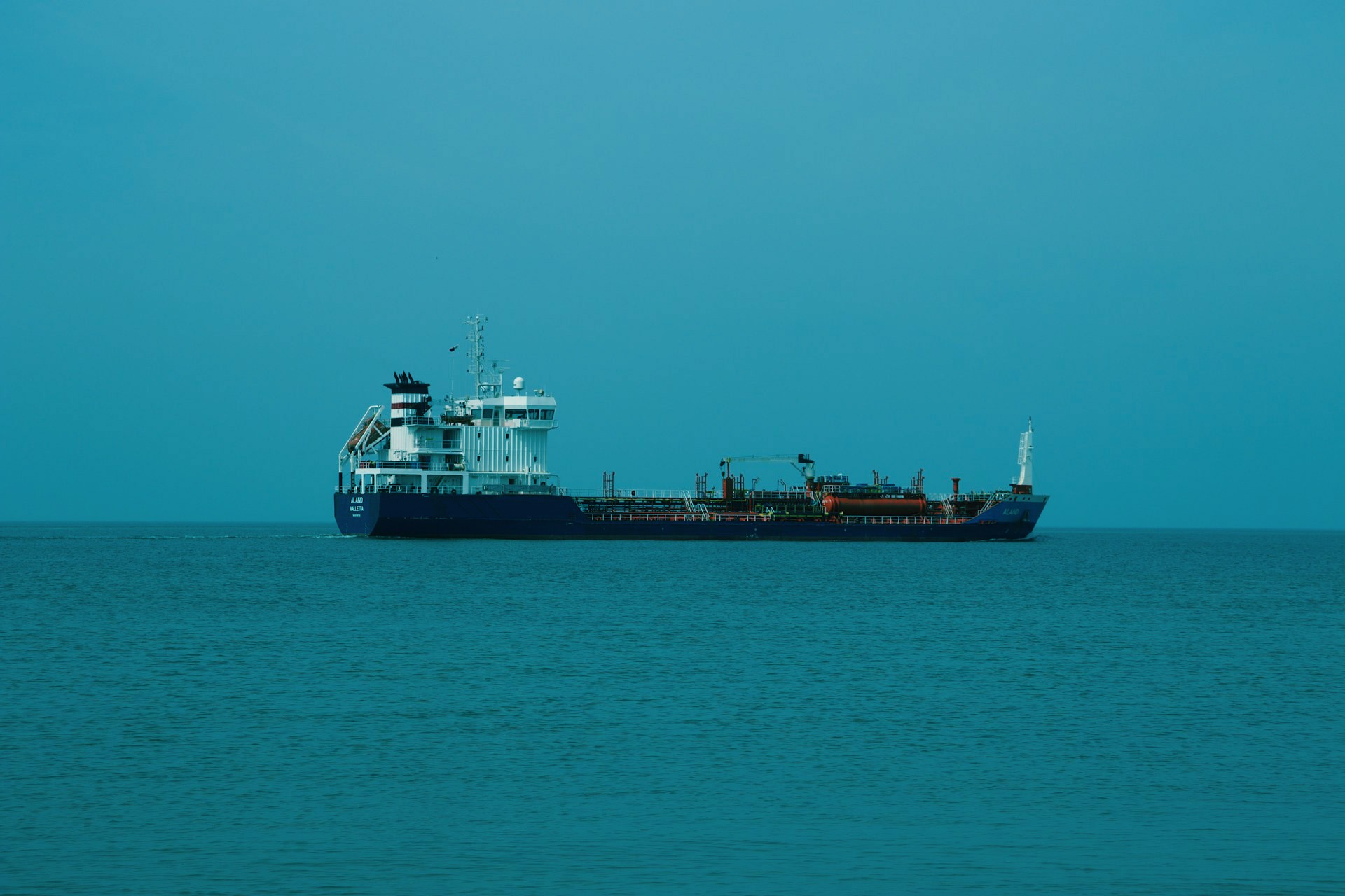 a large cargo ship in the middle of the ocean