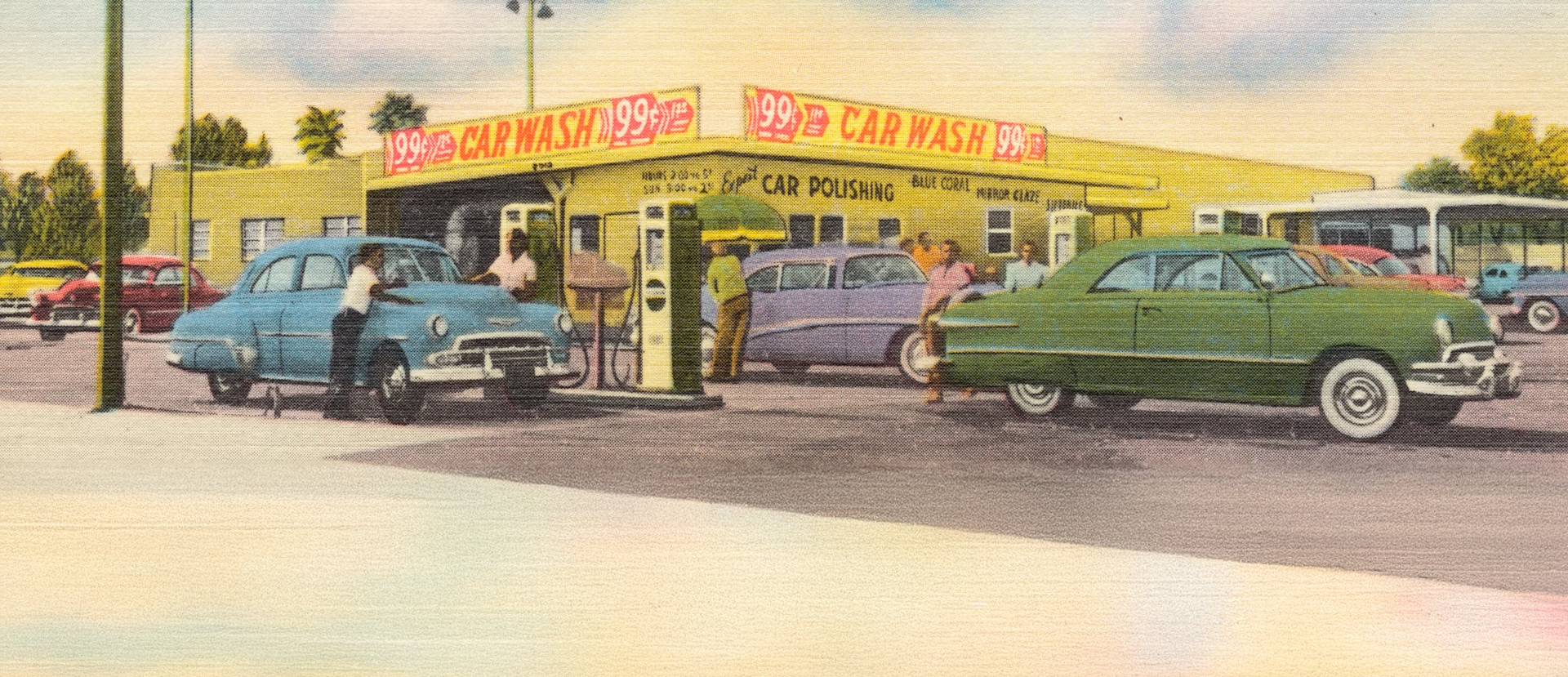 green car parked in front of store