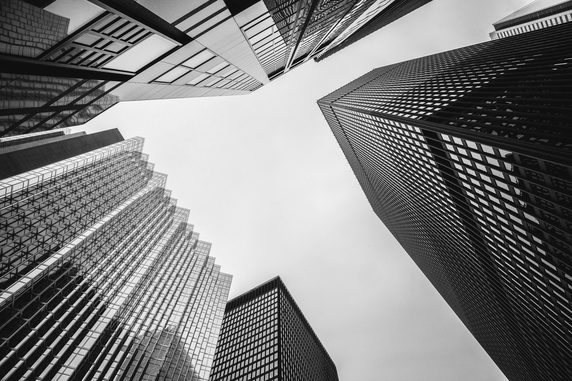 an abstract photo of a curved building with a blue sky in the background
