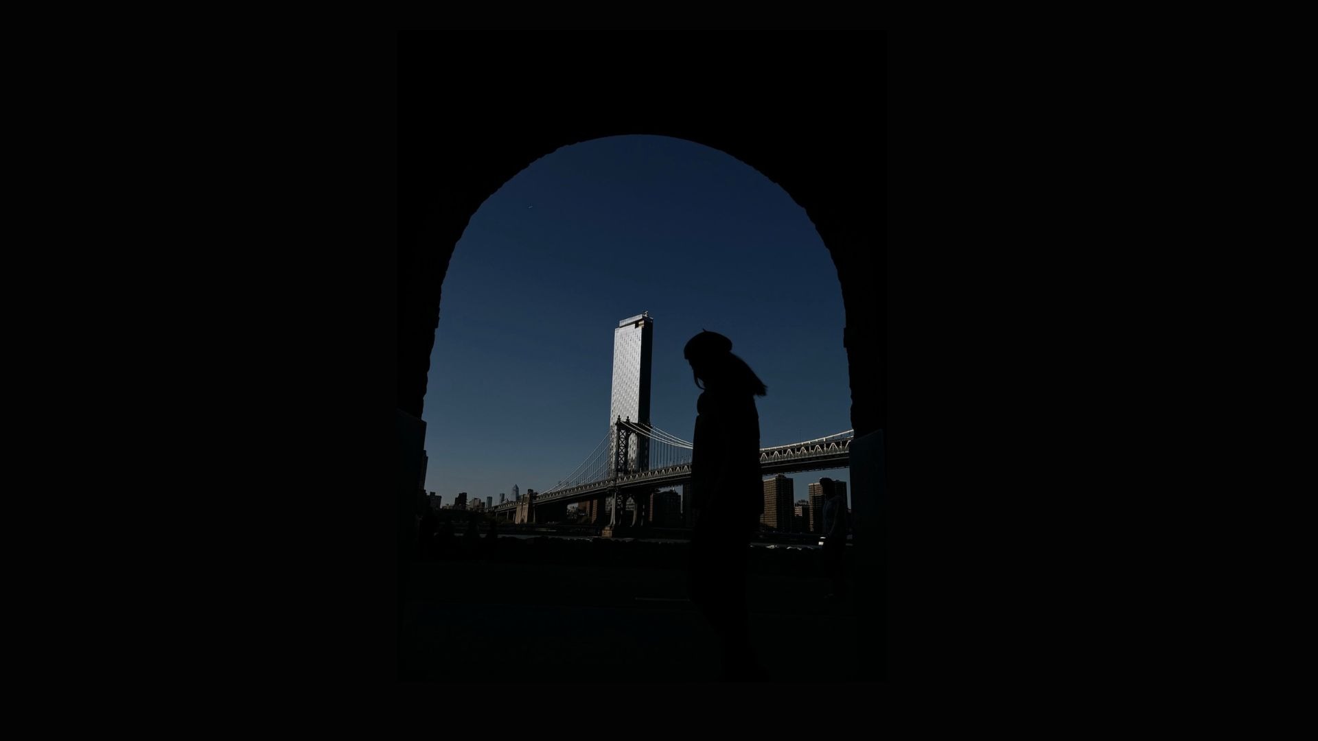 an abstract photo of a curved building with a blue sky in the background