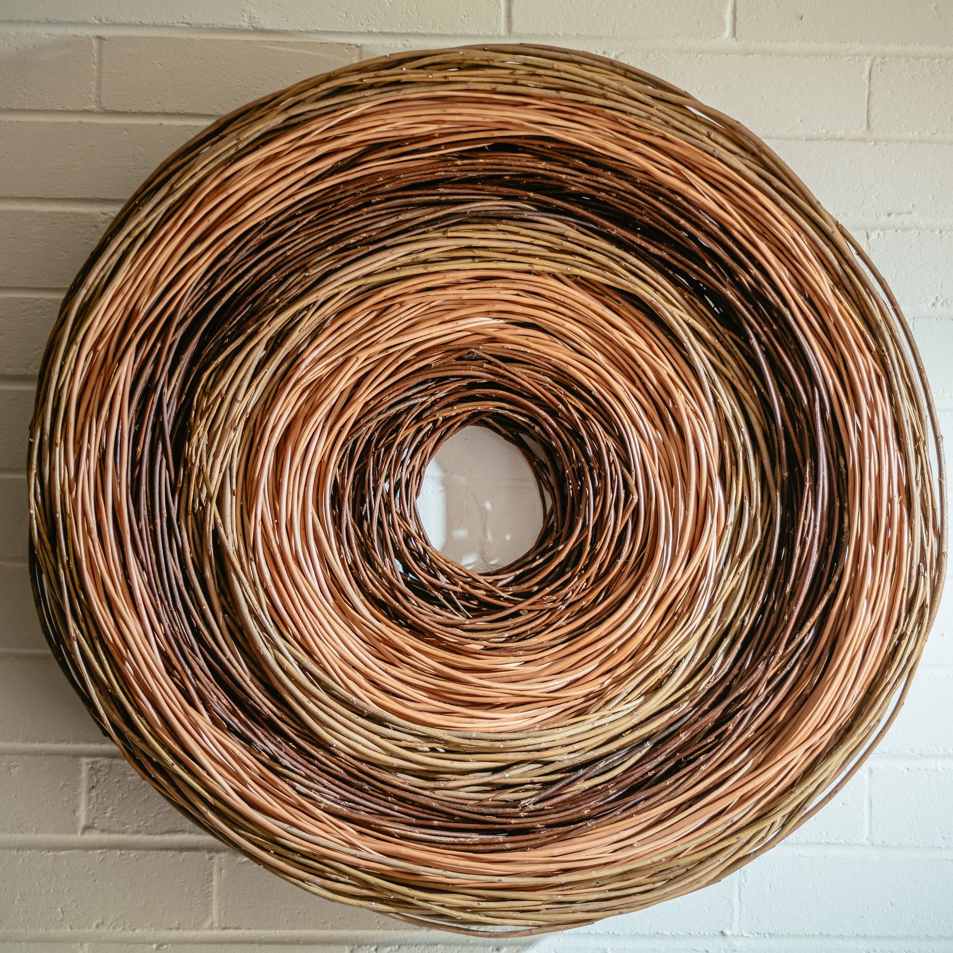 Modern circular wall art made from sustainable willow in colour bands