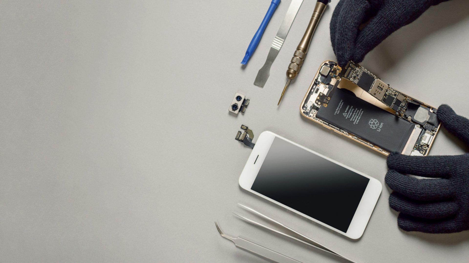 Cracked phone disassembled for repair.