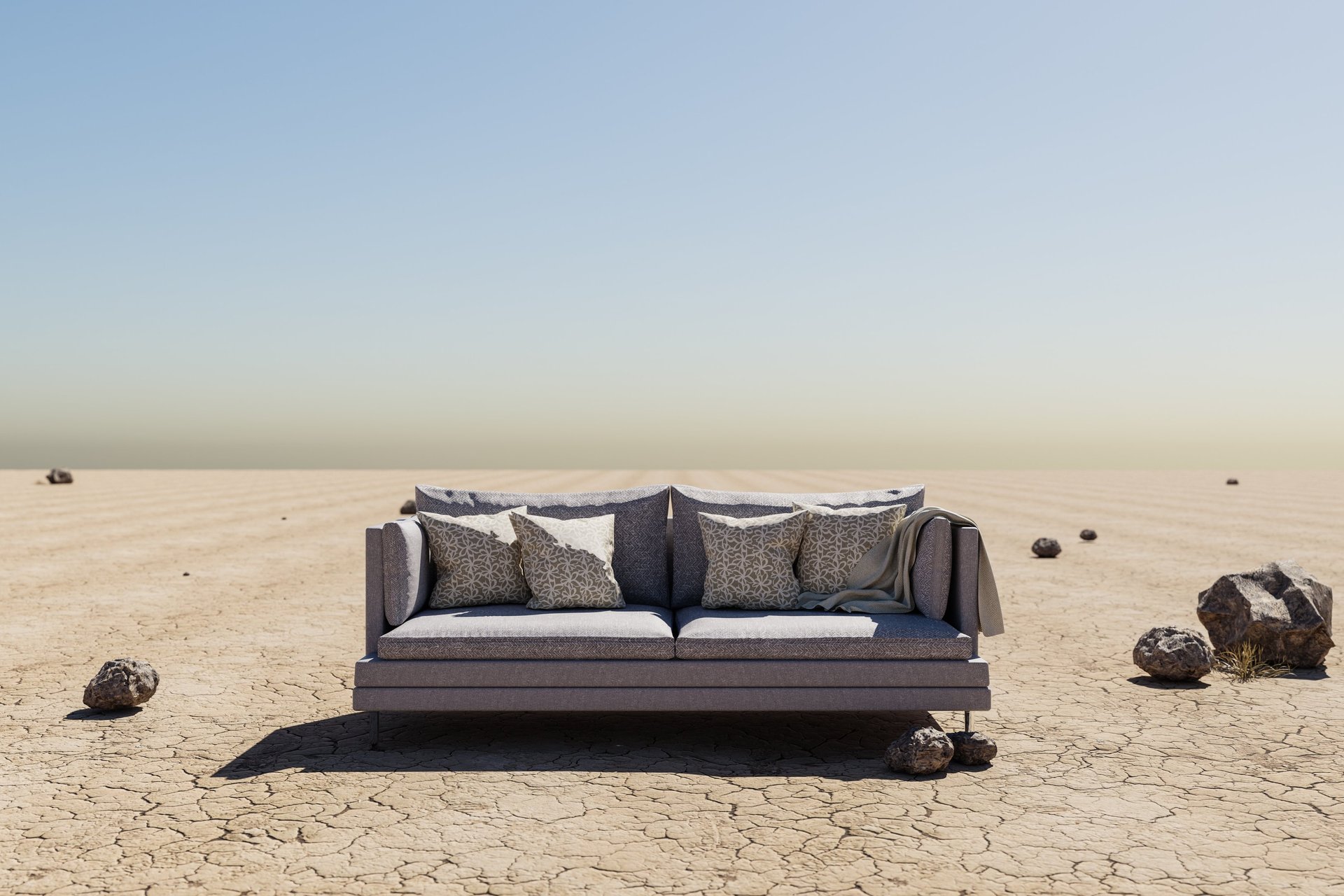 red couch in a field of grass with clouds