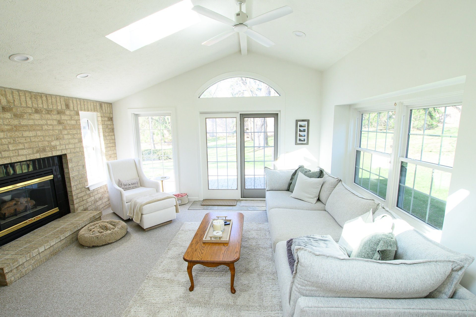 white sofa chair near fireplace
