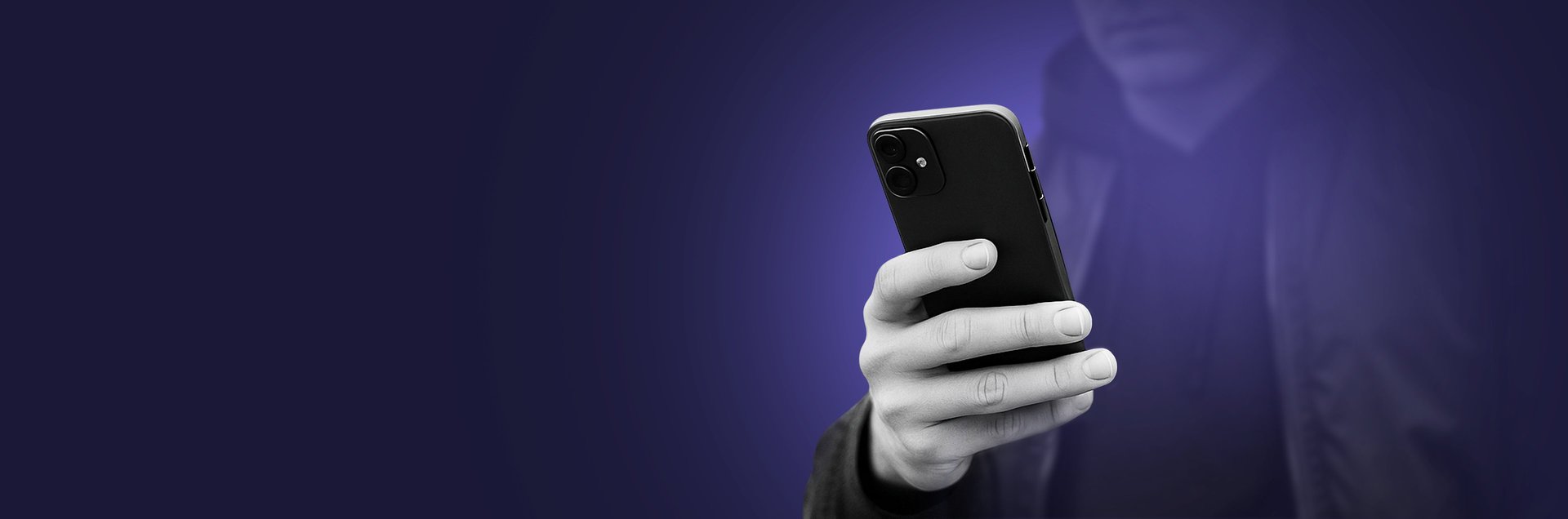 A man holding a phone reading from the screen