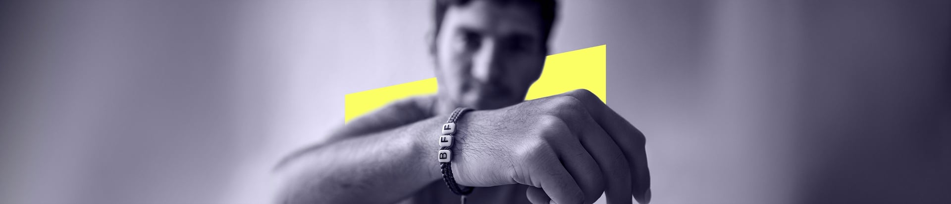 Wide banner photo of two friends clasping hands symbolising brotherhood