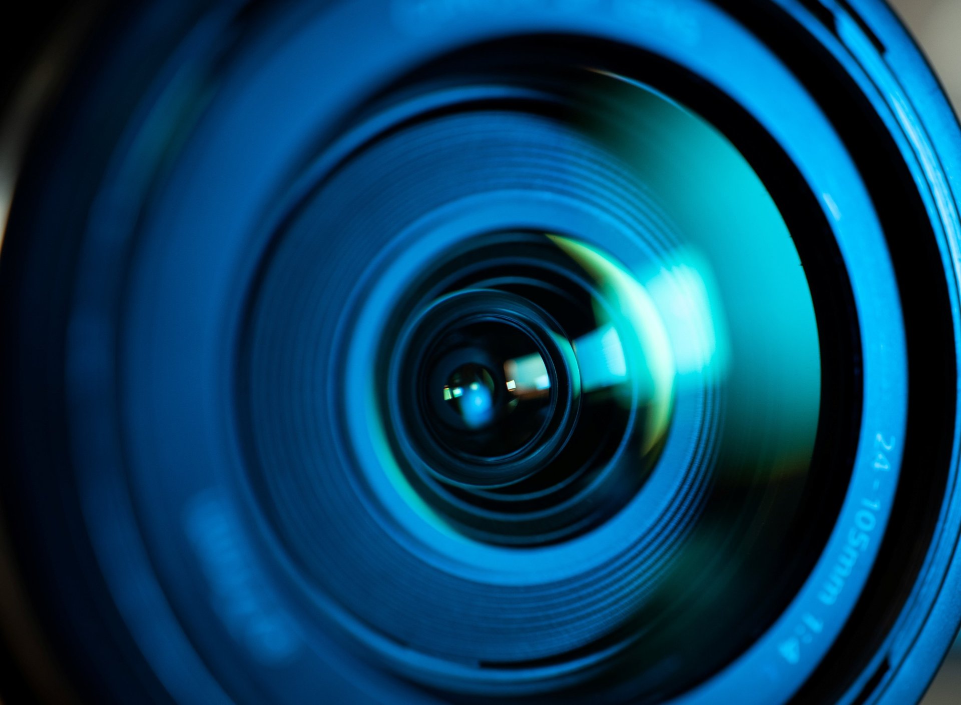 an abstract photo of a curved building with a blue sky in the background