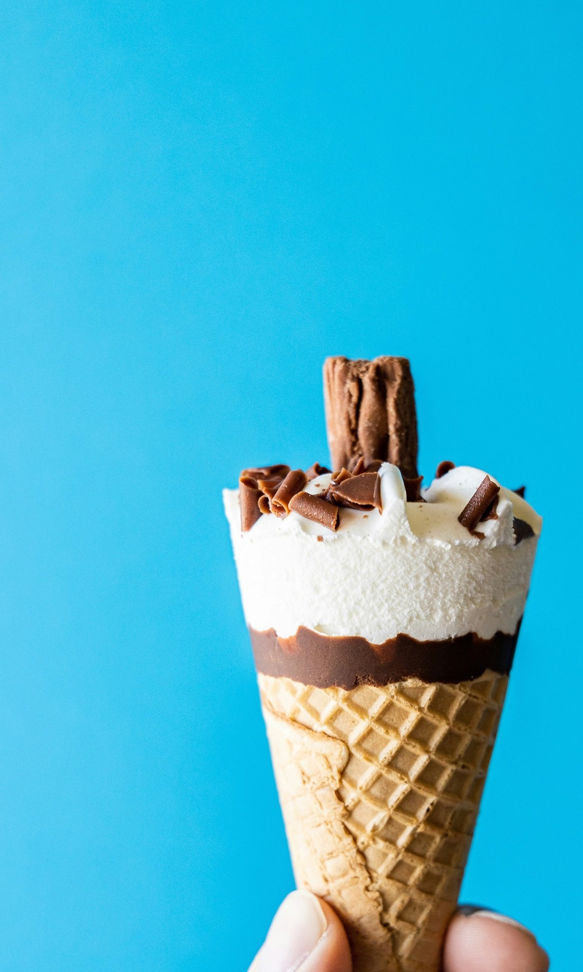 white ice cream on brown cone