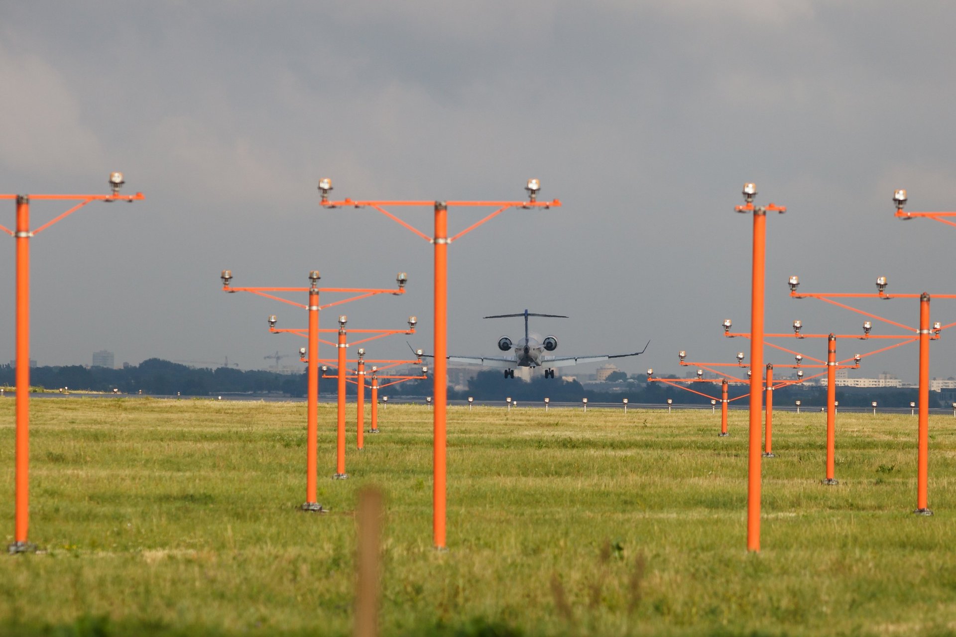 four jets flying in formation in a blue sky