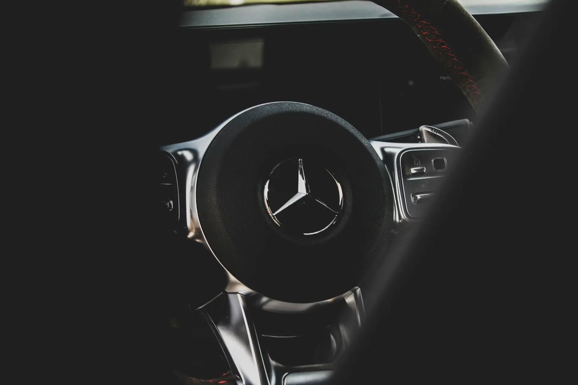 A car dashboard with a steering wheel and a dash board