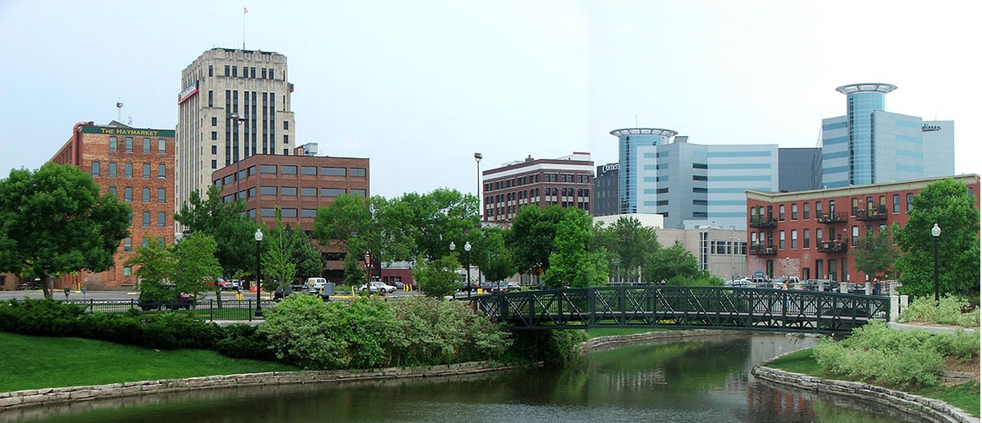 blue bridge over river near city buildings during daytime