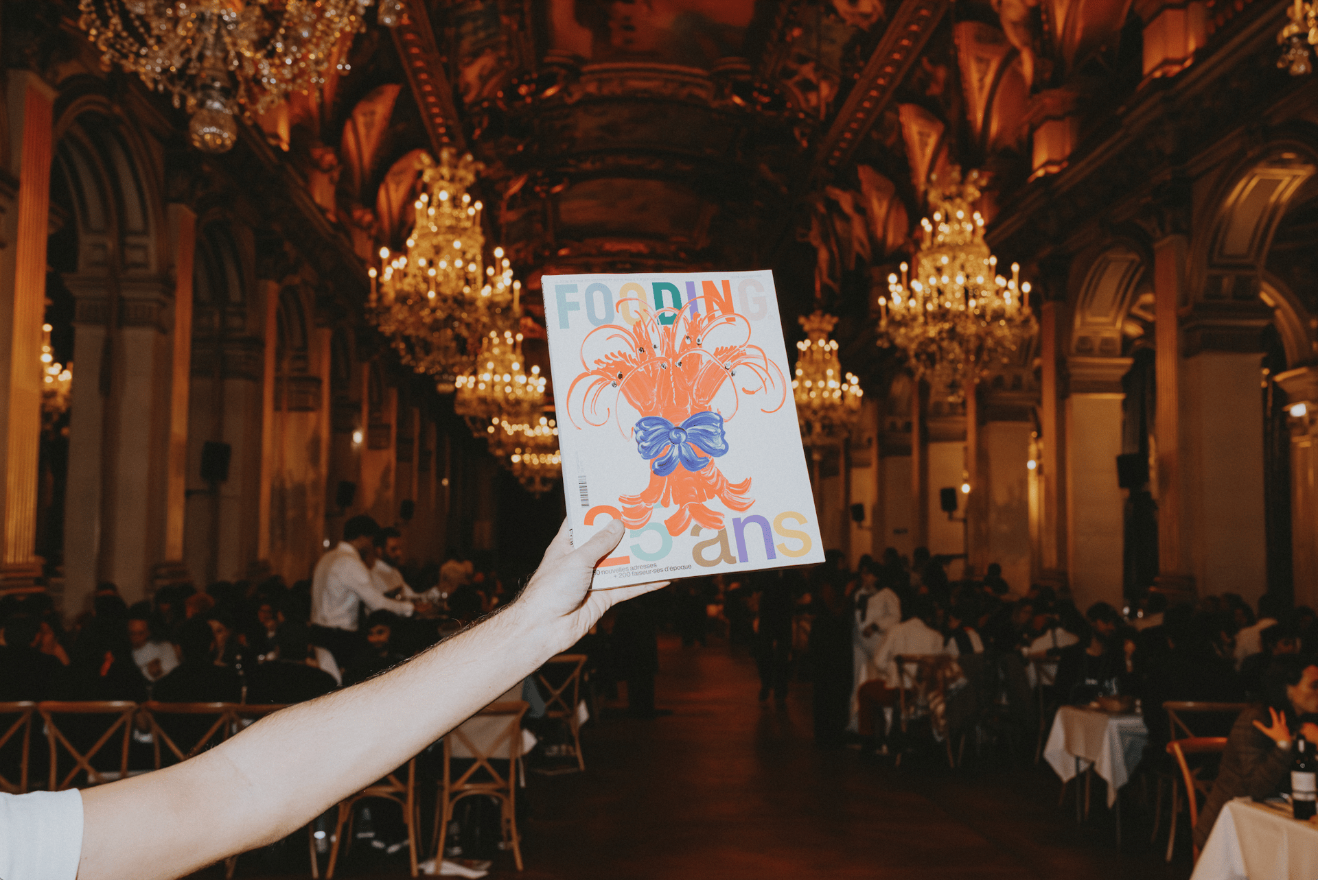 a group of people sitting at tables outside of a restaurant