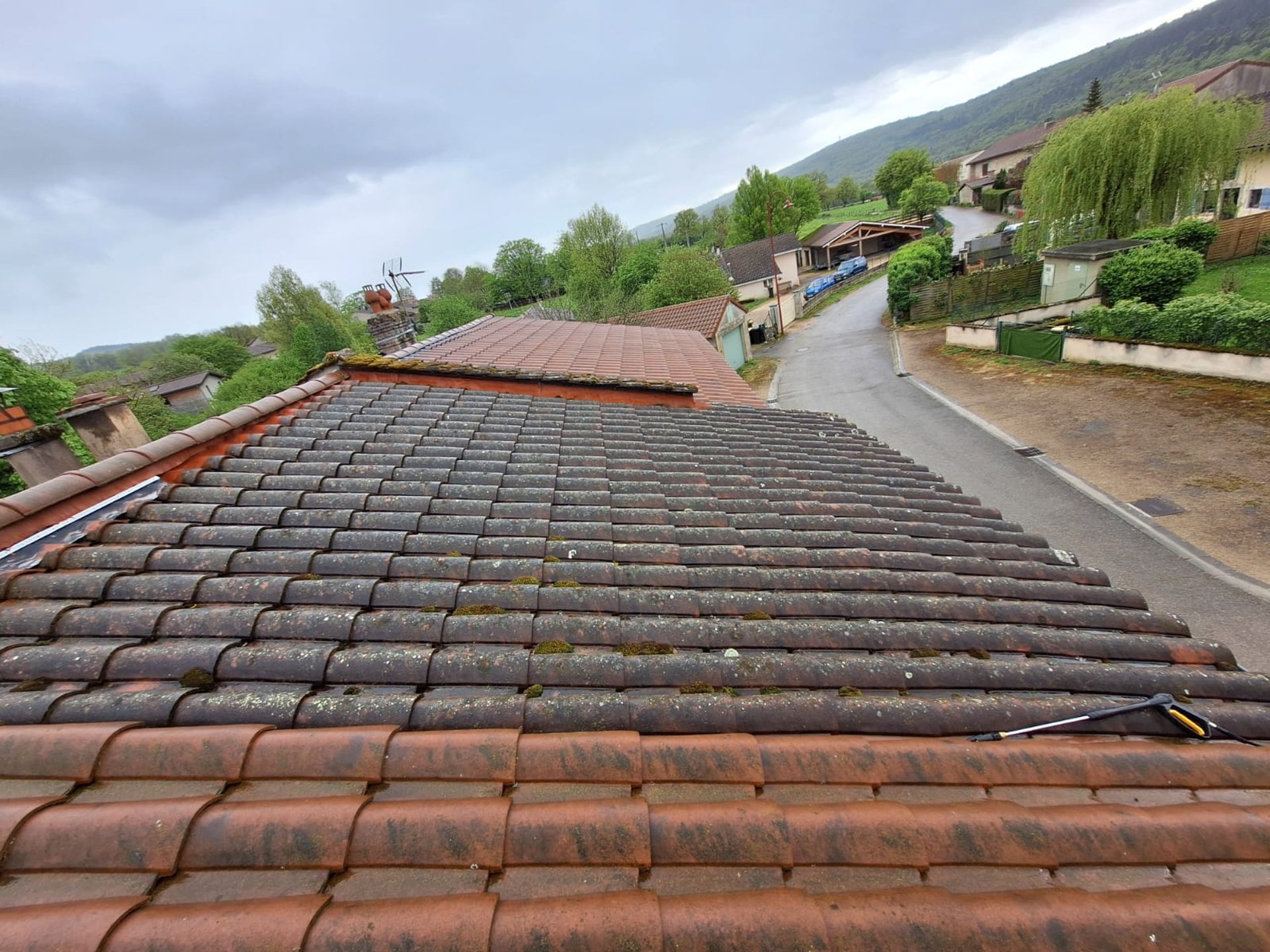 a man on a roof working with a rope