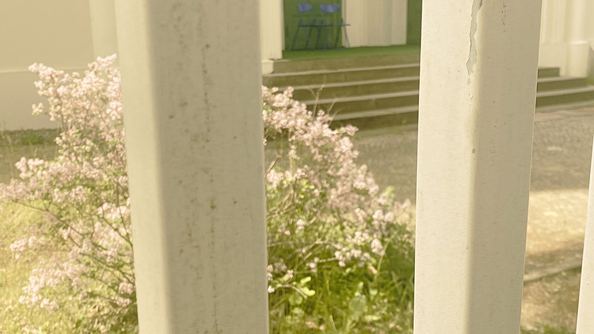 Dark stage with single spotlight illuminating performer – film still from Lingua Materna by Tina Bikic