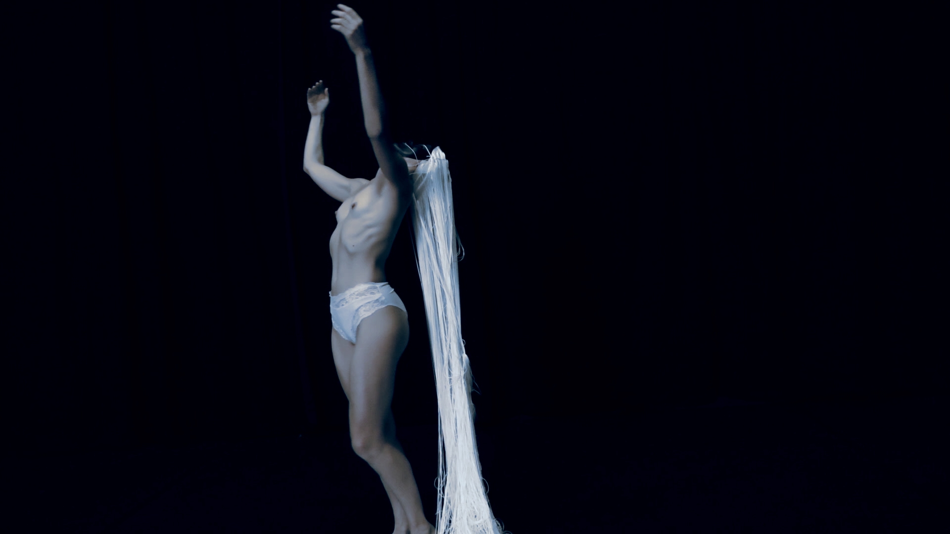 Film still from “Der Schatten” by Tina Bikic showing a dancer in motion, wearing a white mask and costume.