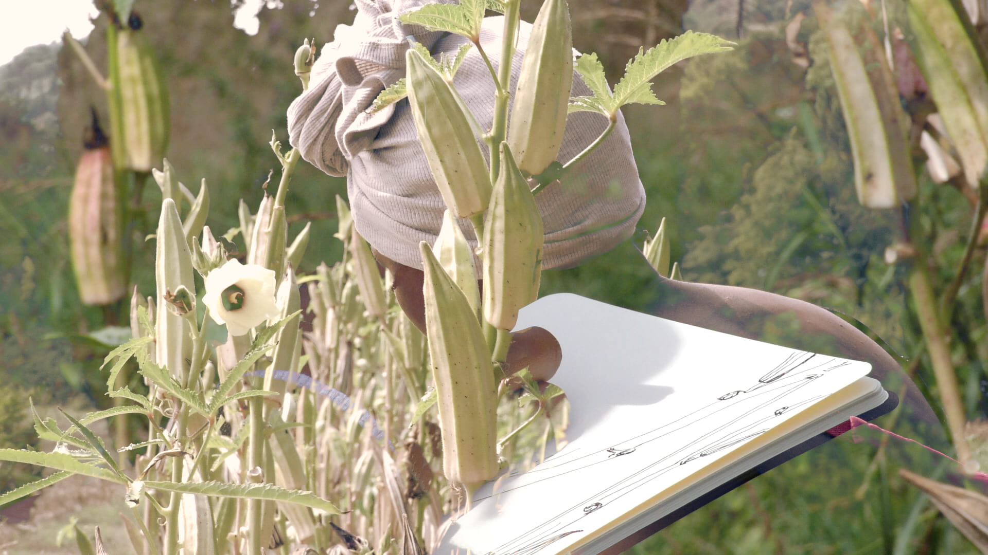Performer partly hidden in tall plants – La distanza di sicurezza by Tina Bikic