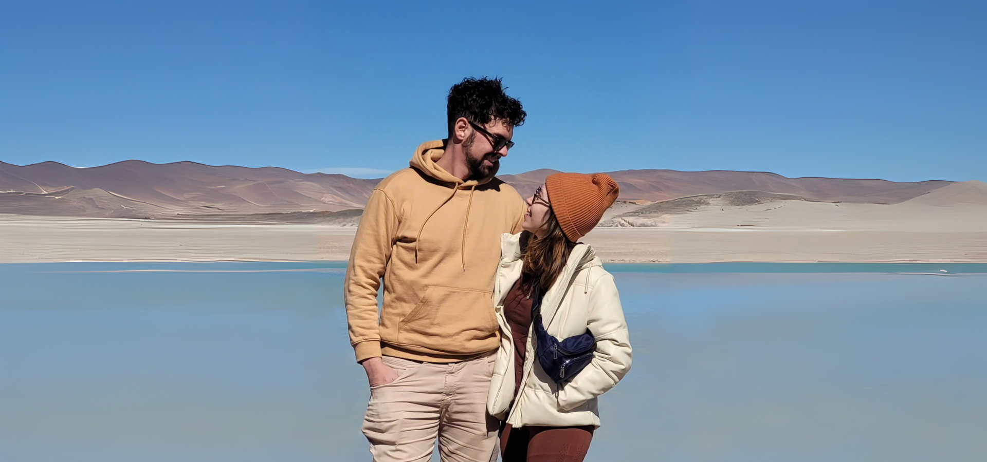 an abstract photo of a curved building with a blue sky in the background