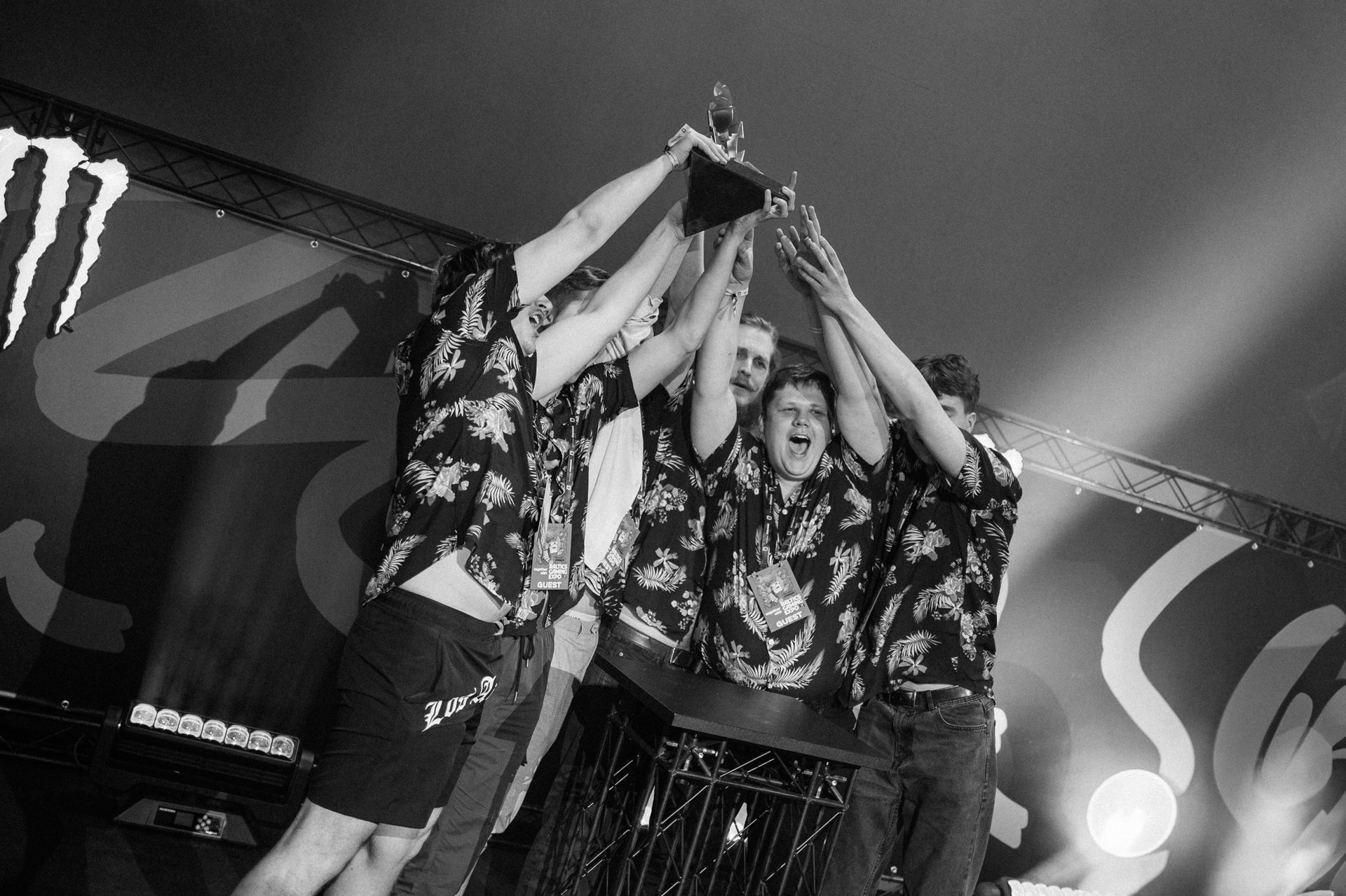 person holding pencil near laptop computer