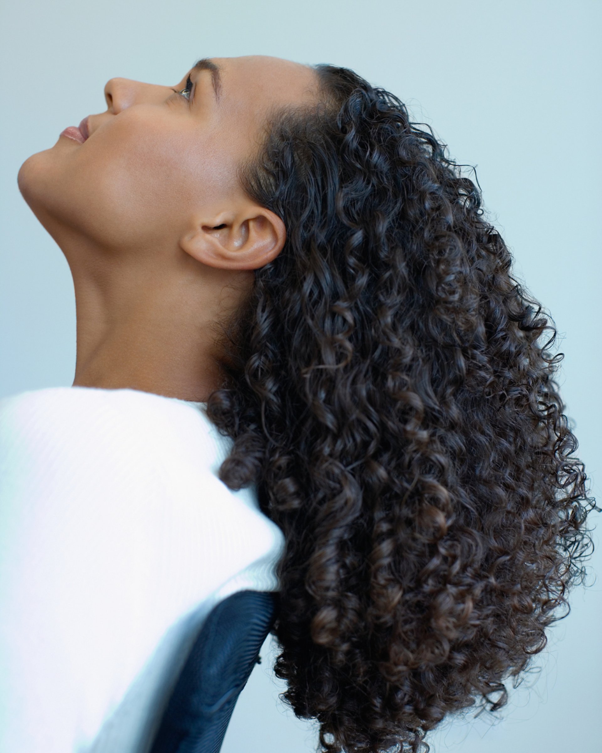 an abstract photo of a curved building with a blue sky in the background