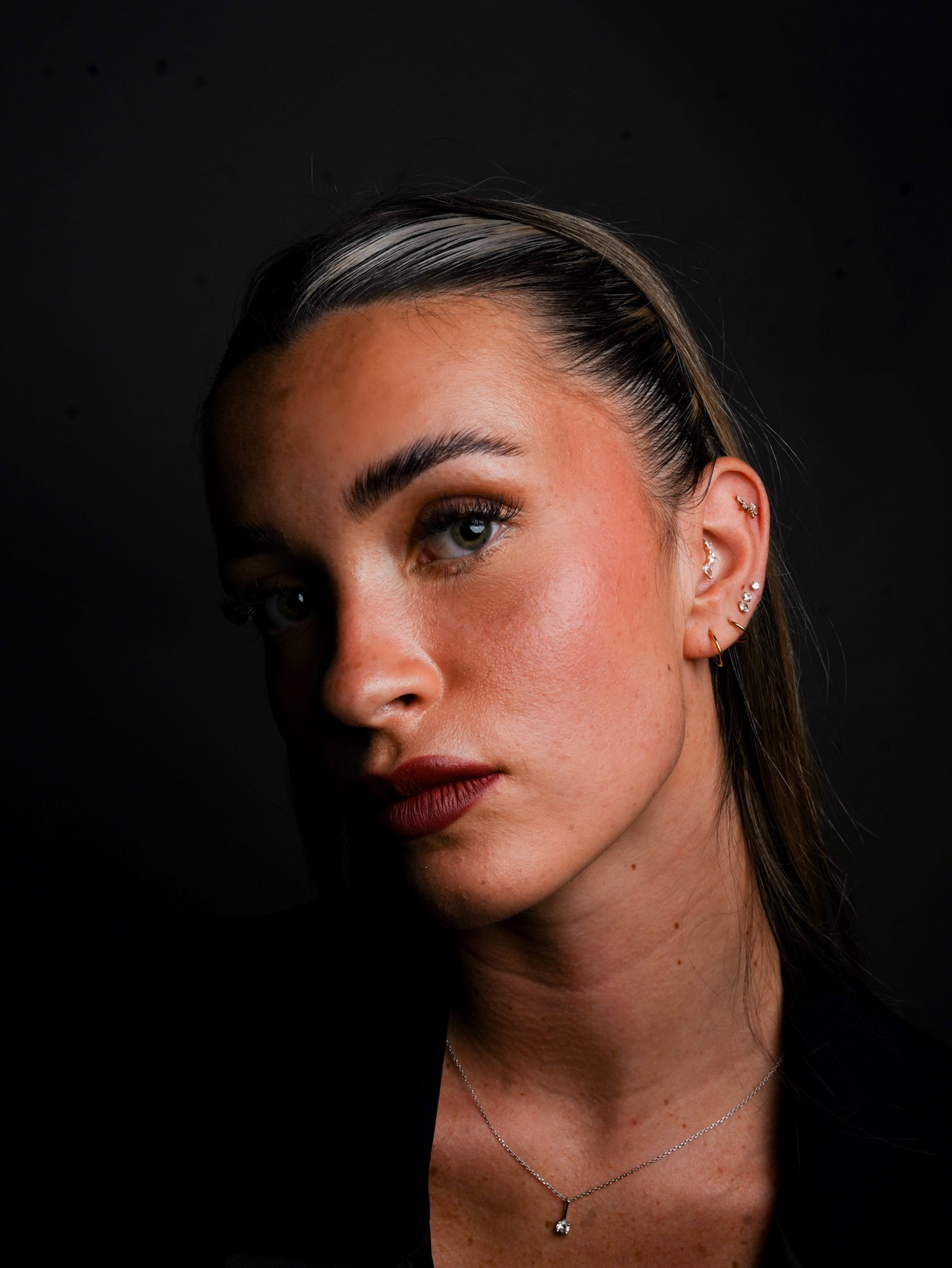 woman in white shirt with silver earrings