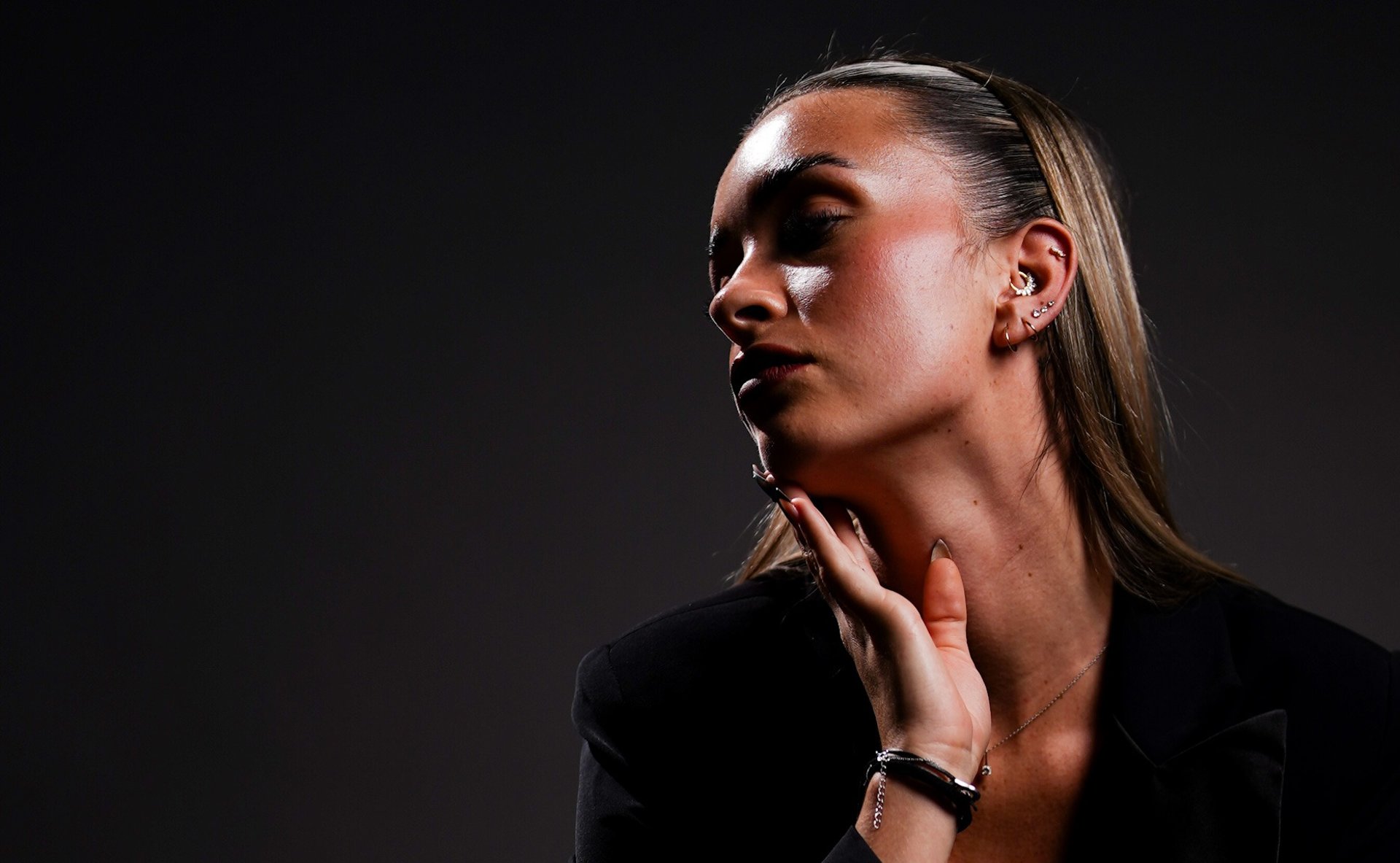 woman with silver and diamond stud earrings