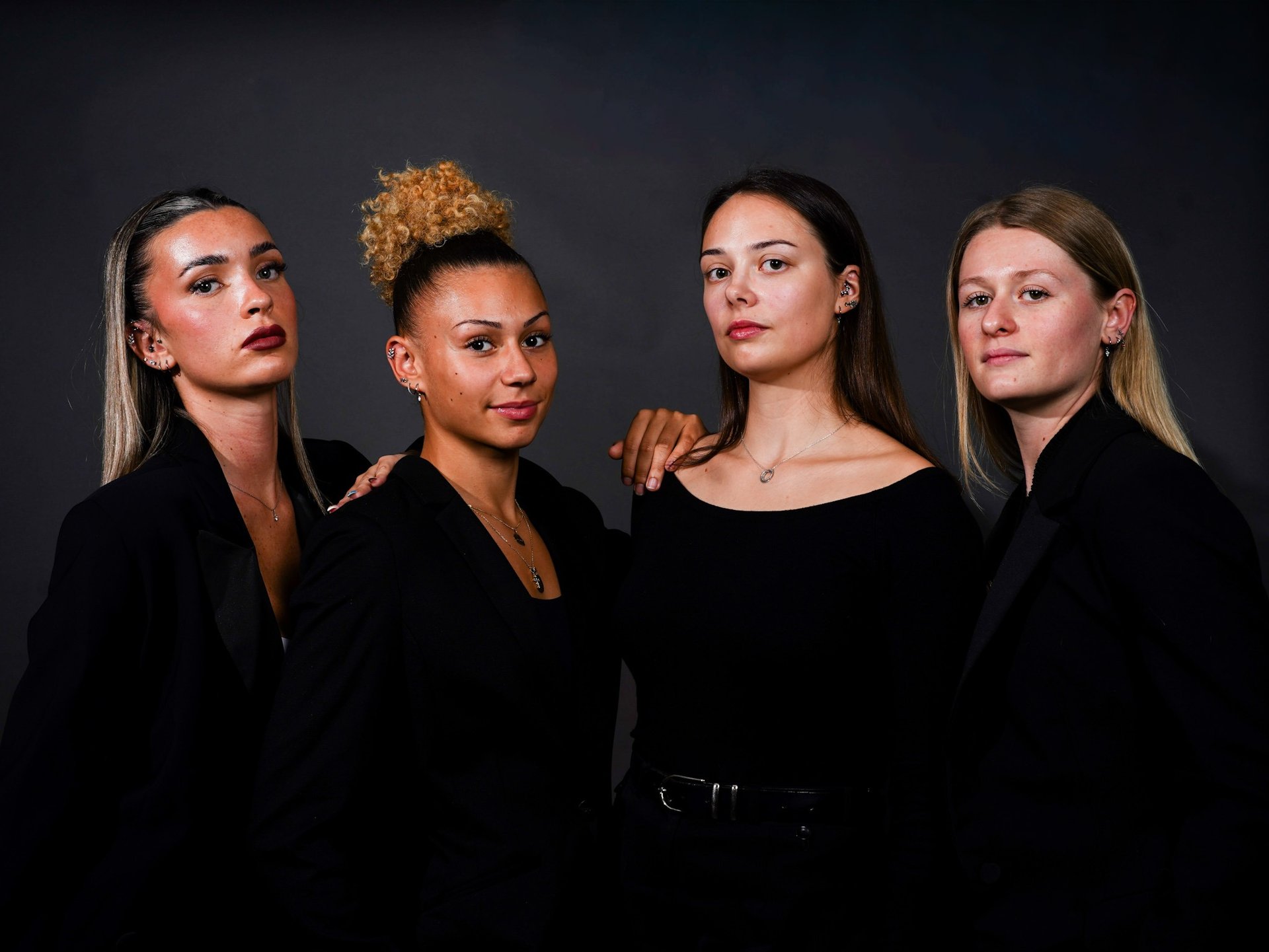 woman with silver and diamond stud earrings