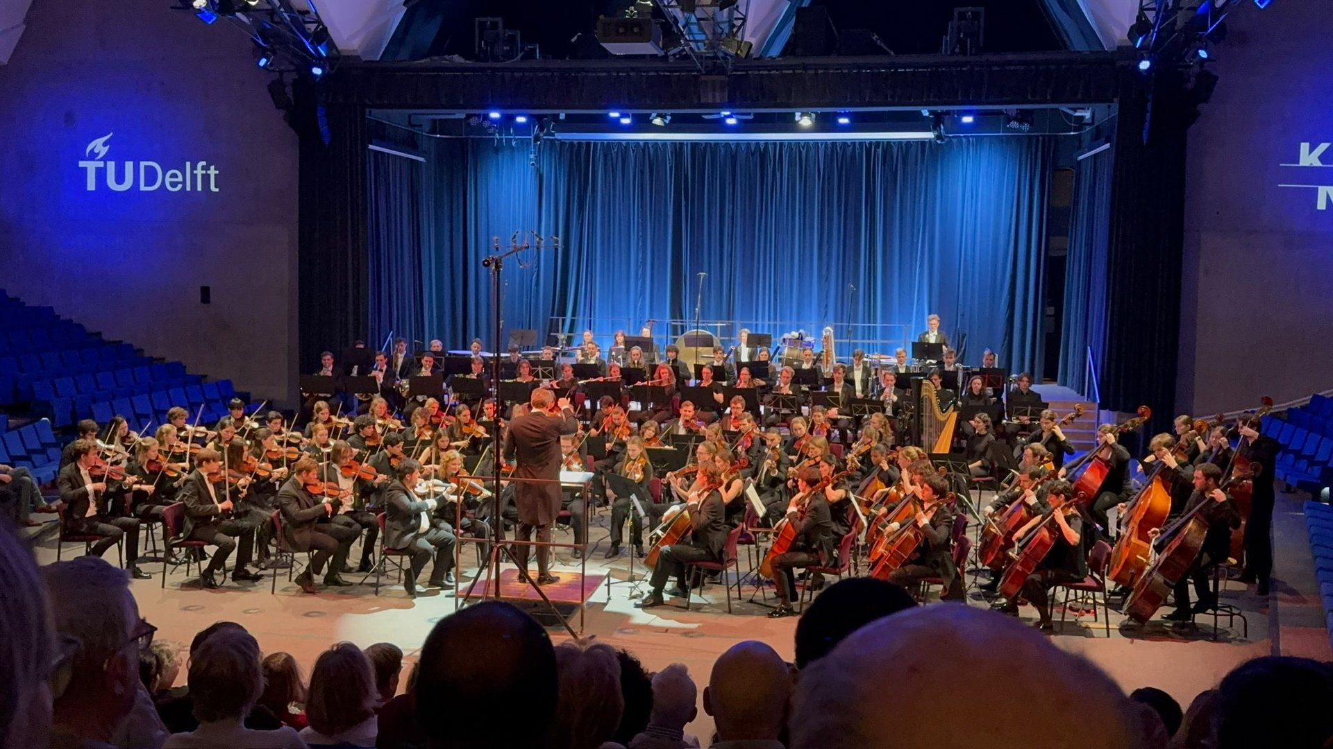 an abstract photo of a curved building with a blue sky in the background