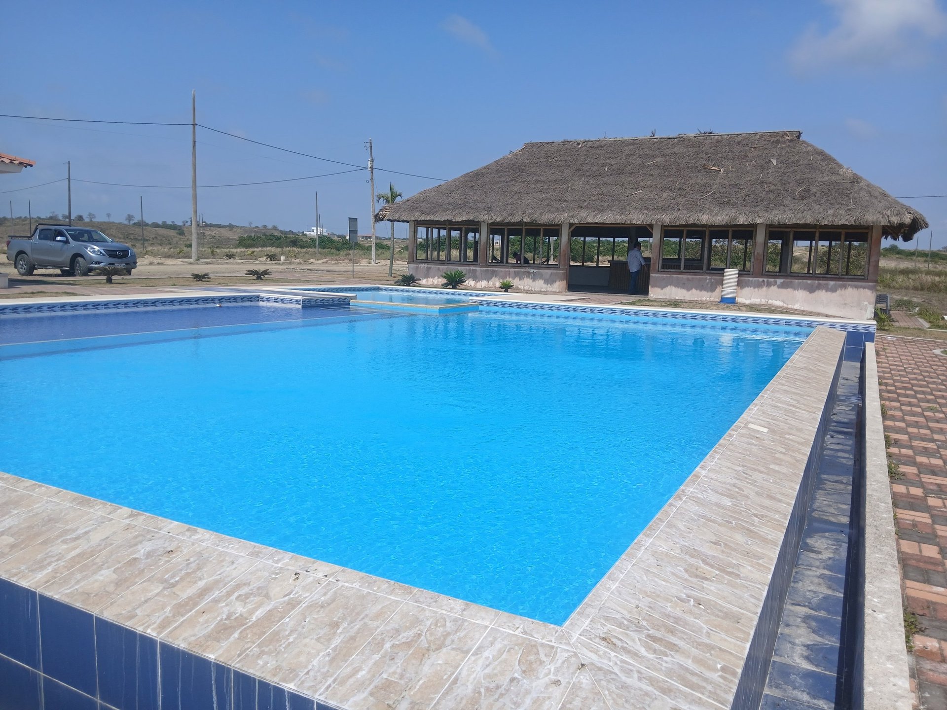 an abstract photo of a curved building with a blue sky in the background