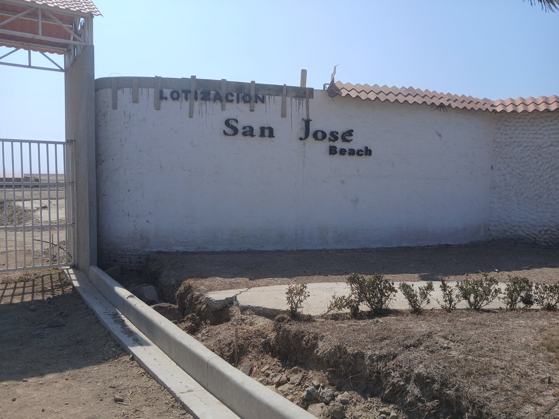 an abstract photo of a curved building with a blue sky in the background