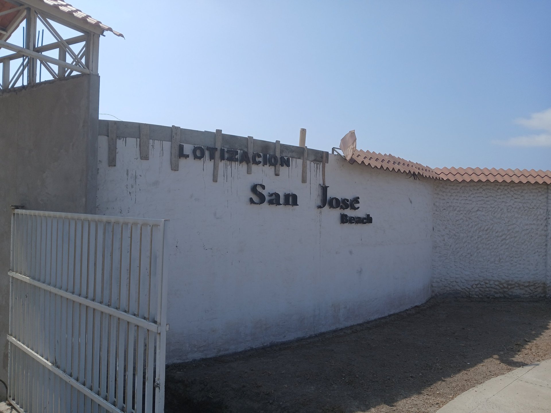 an abstract photo of a curved building with a blue sky in the background