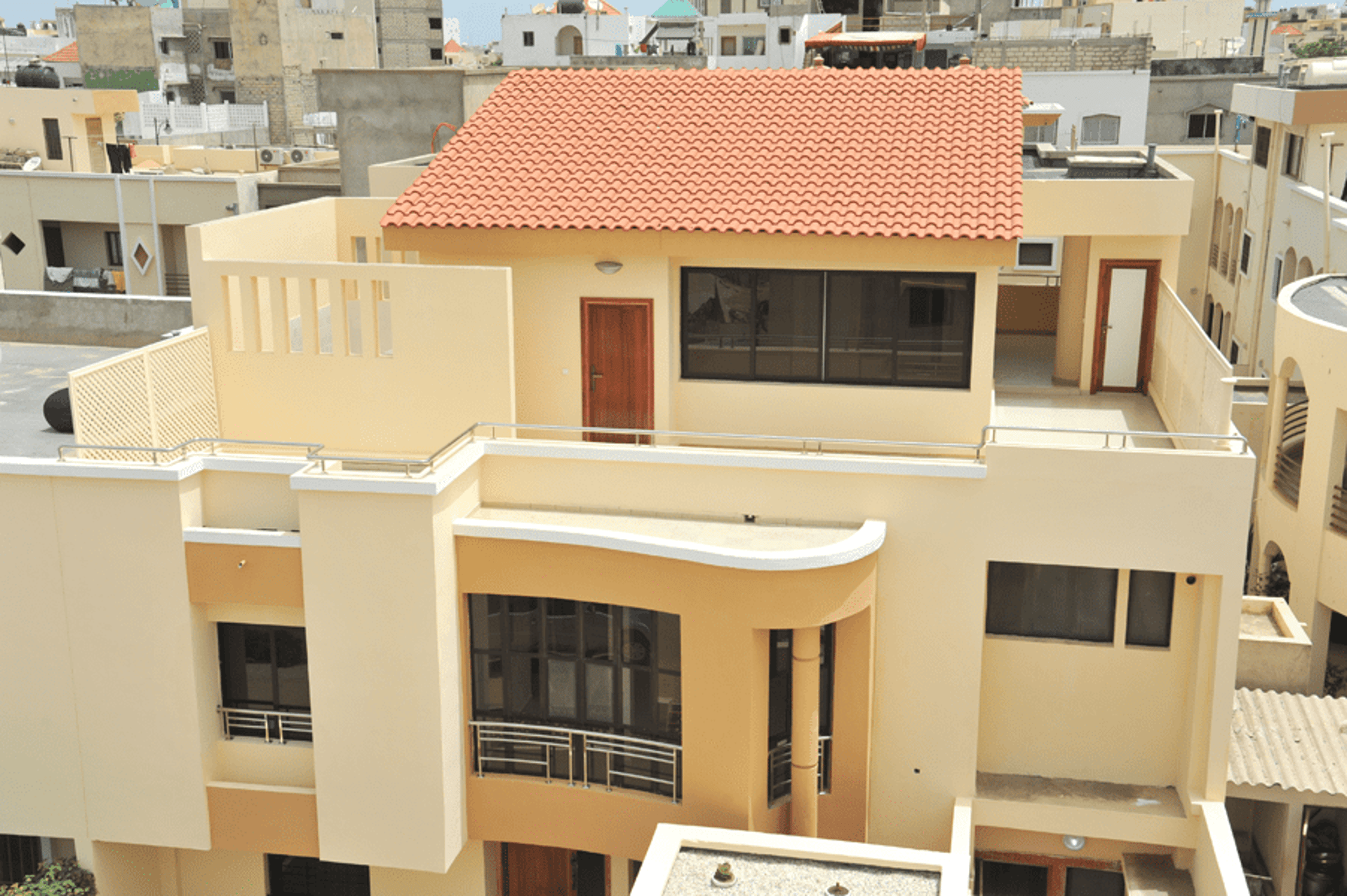 an abstract photo of a curved building with a blue sky in the background