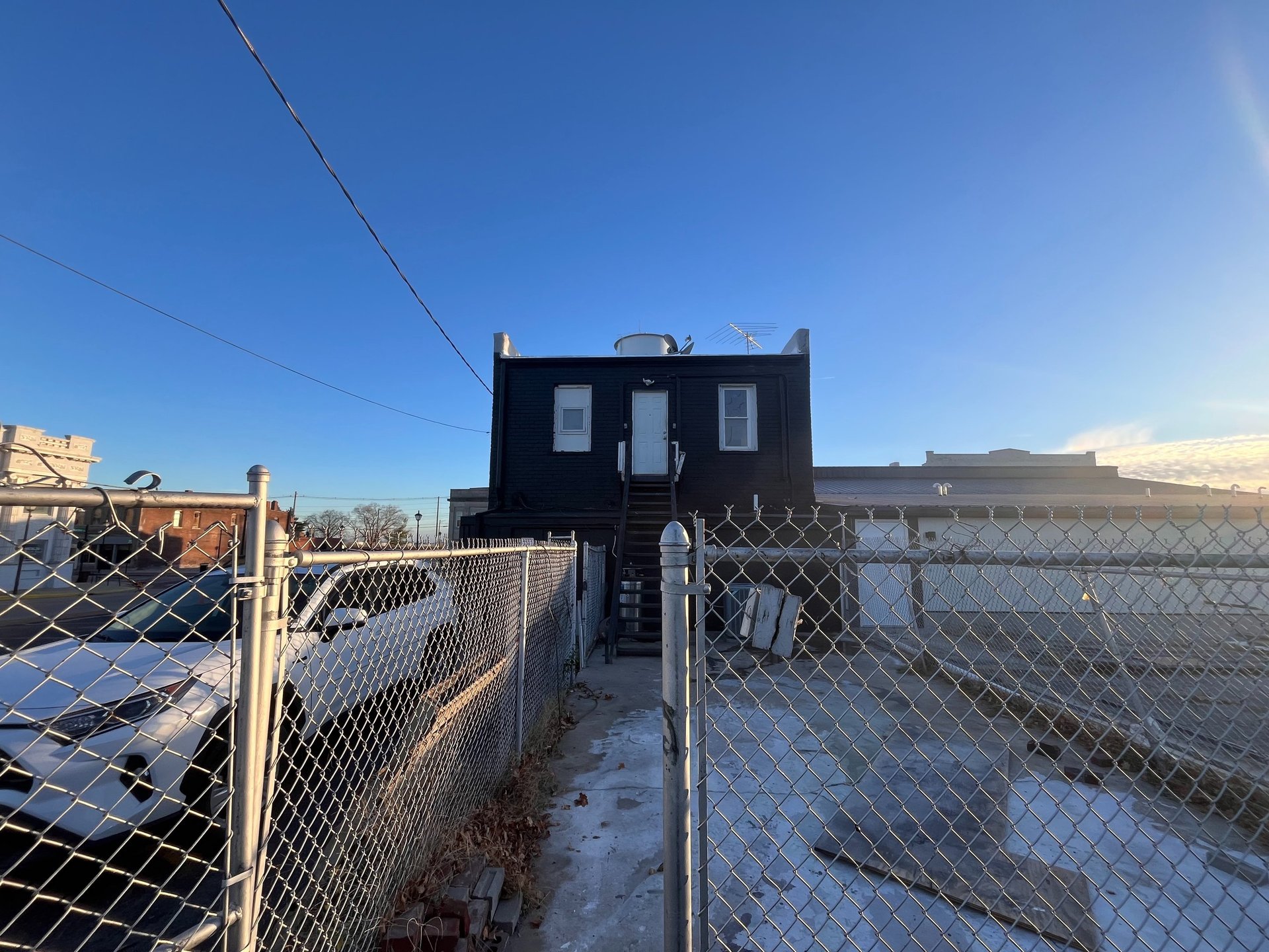 an abstract photo of a curved building with a blue sky in the background