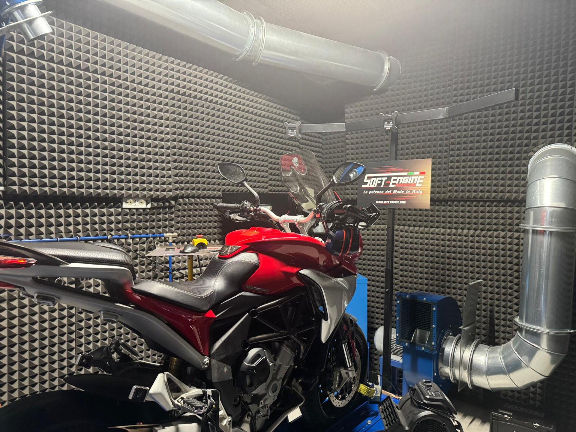 a motorcycle parked in a field on a sunny day