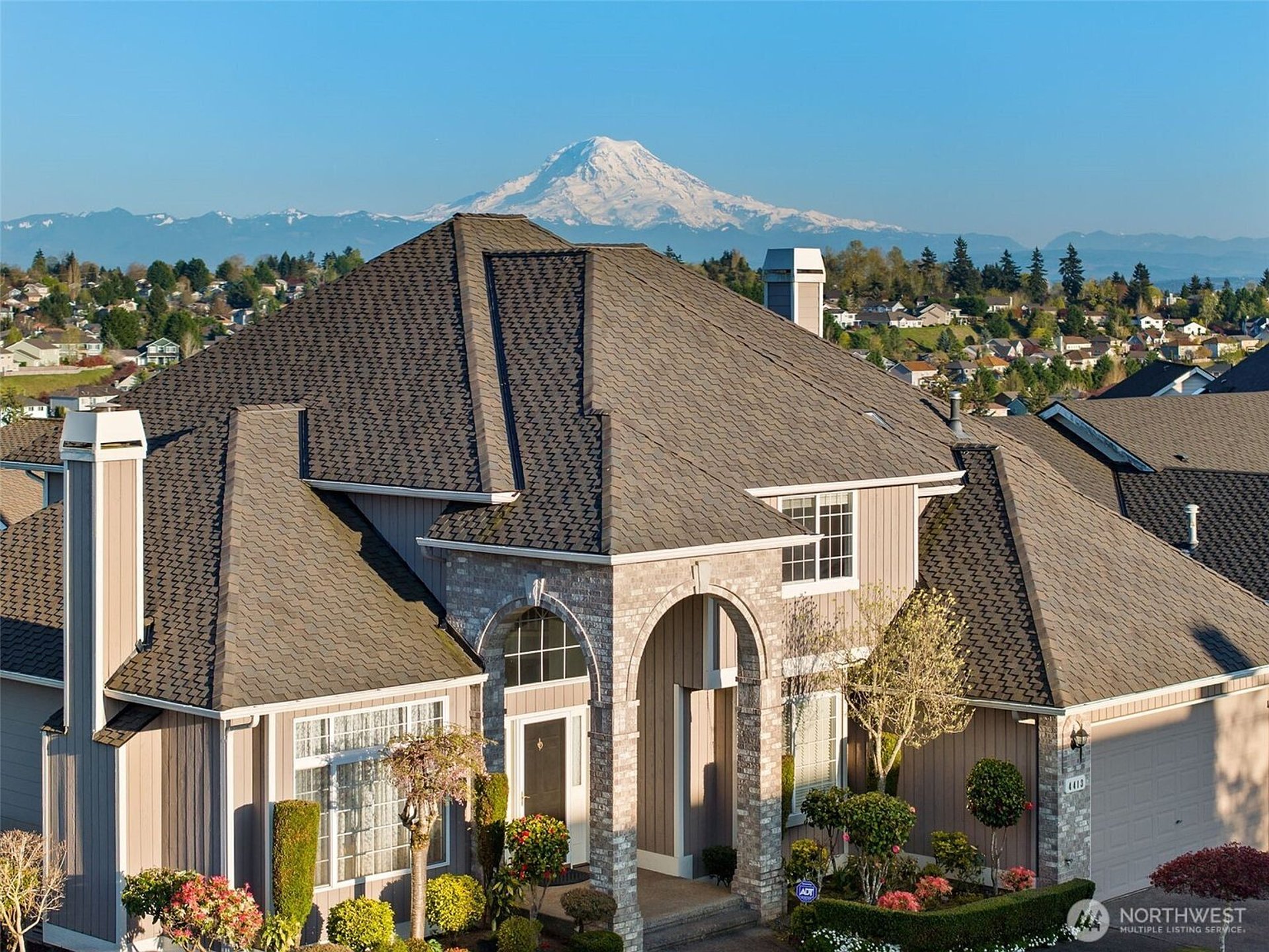 an abstract photo of a curved building with a blue sky in the background
