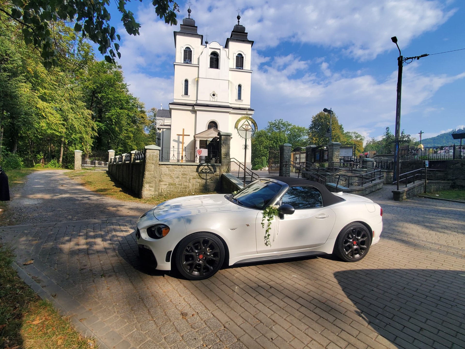 a white convertible car on a road