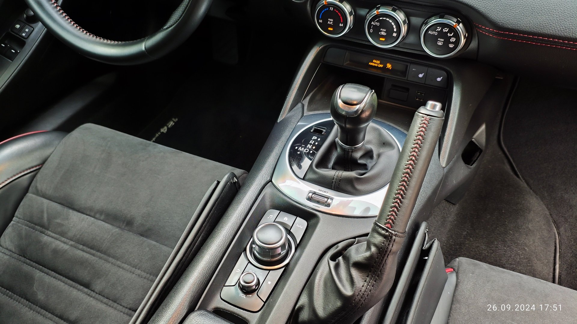 a white convertible car on a road