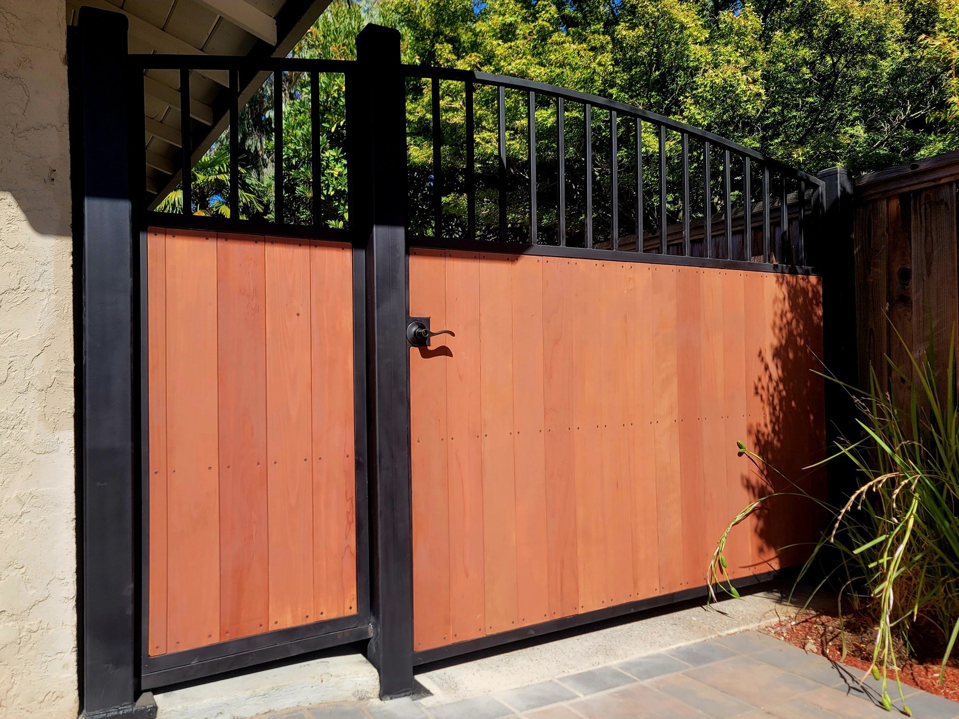 a wooden fence is reflected in the water
