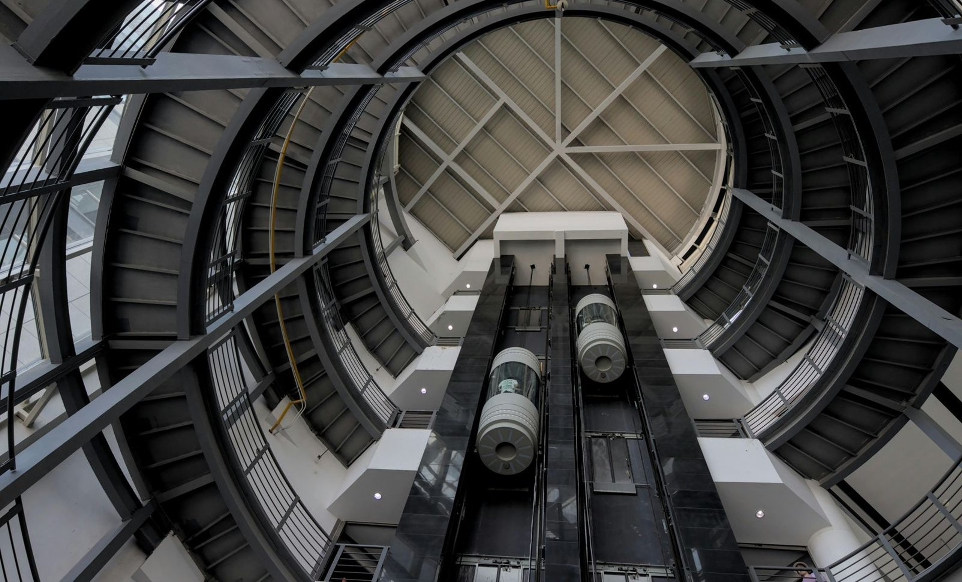 an abstract photo of a curved building with a blue sky in the background