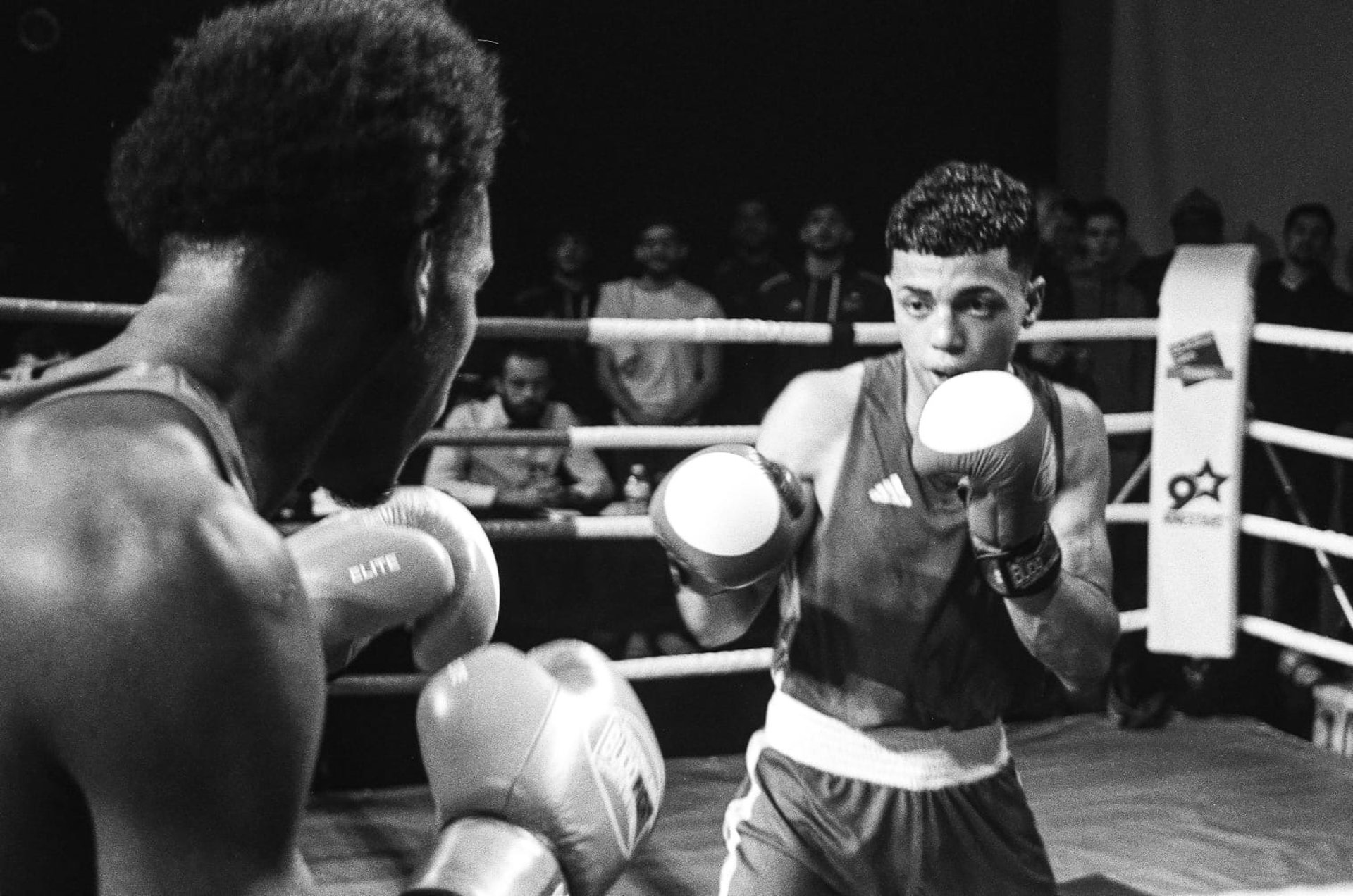 a man in a gym wearing boxing gloves