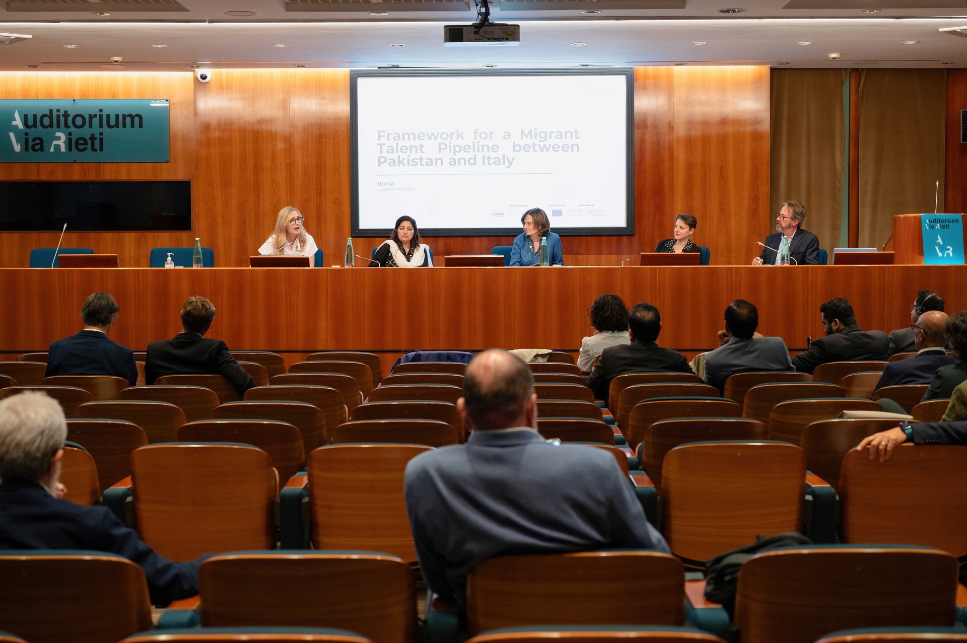 an abstract photo of a curved building with a blue sky in the background