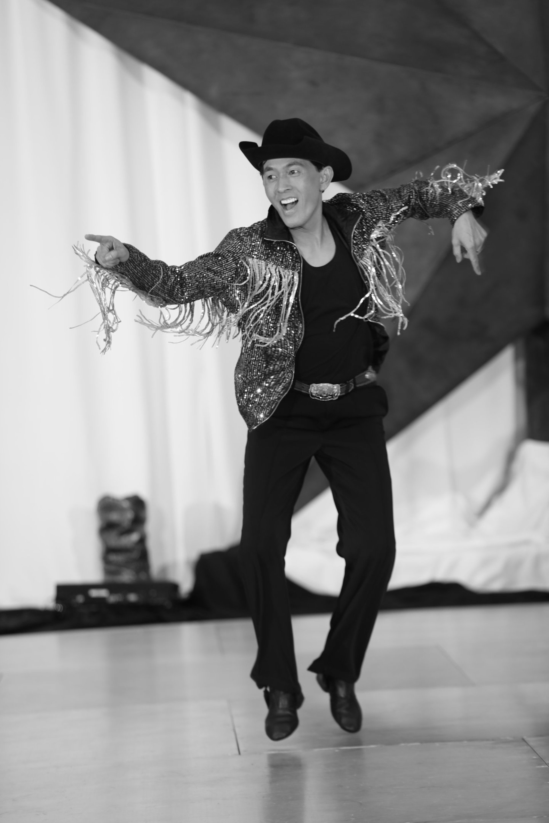 man wearing white shirt holding hands with woman wearing white pants