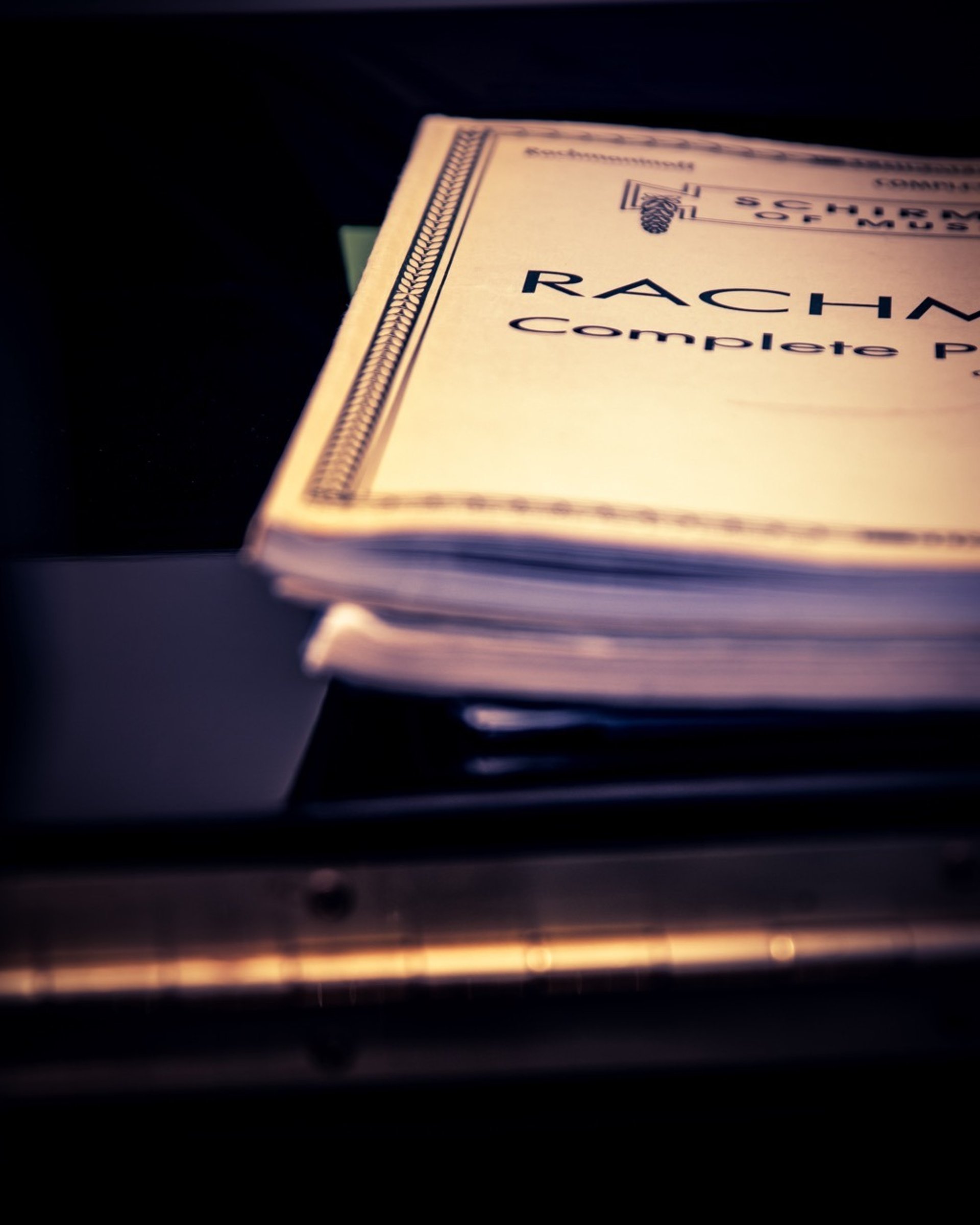 stack of music books on composer Jen Smith Lanthier's piano