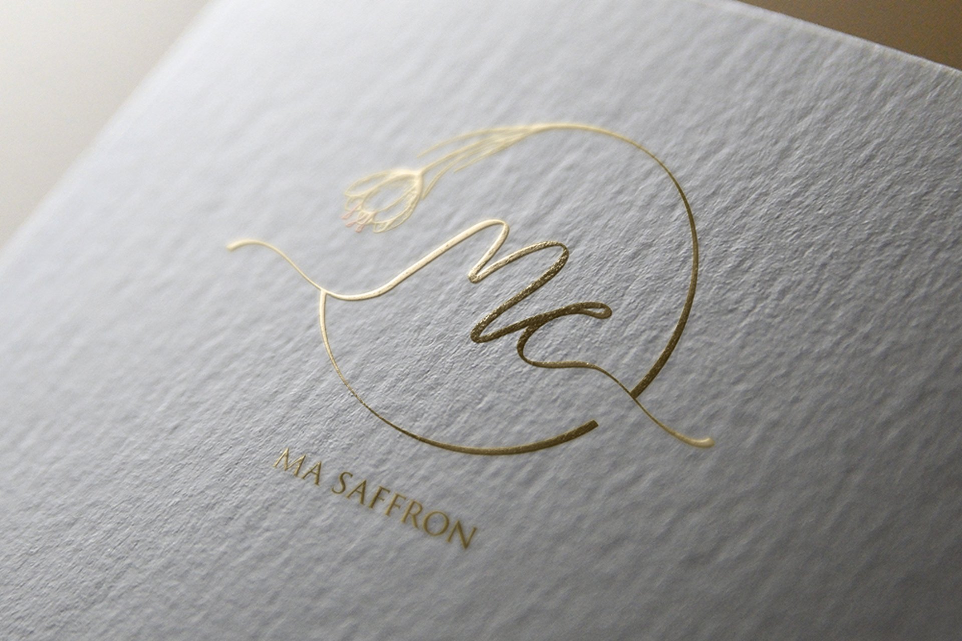 masaffron logo in gold color printed on a white paper