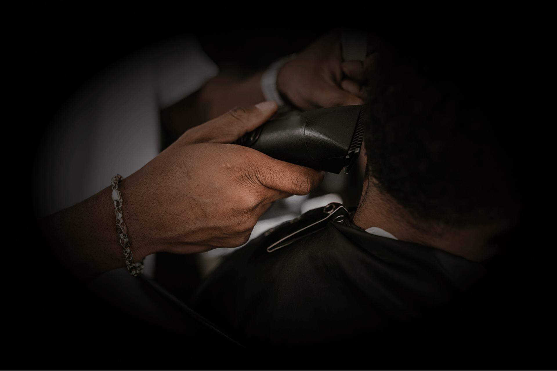 a man cutting another man's hair
