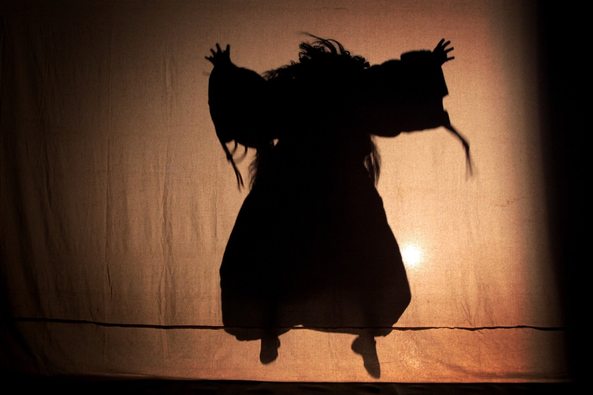 woman wearing yellow long-sleeved dress under white clouds and blue sky during daytime
