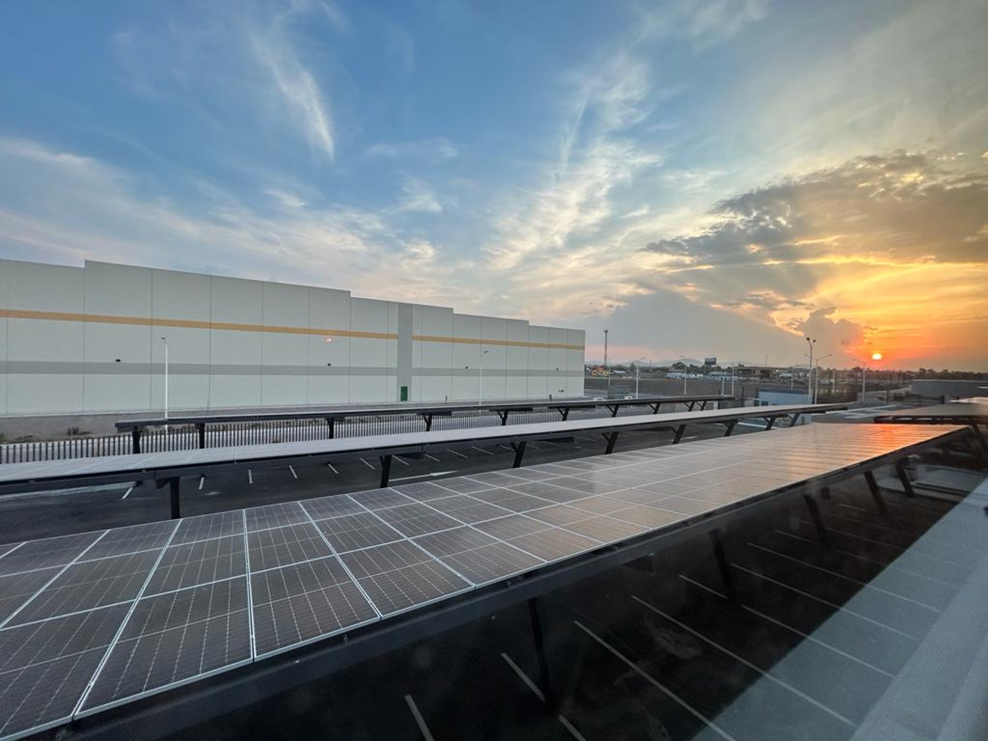 an abstract photo of a curved building with a blue sky in the background