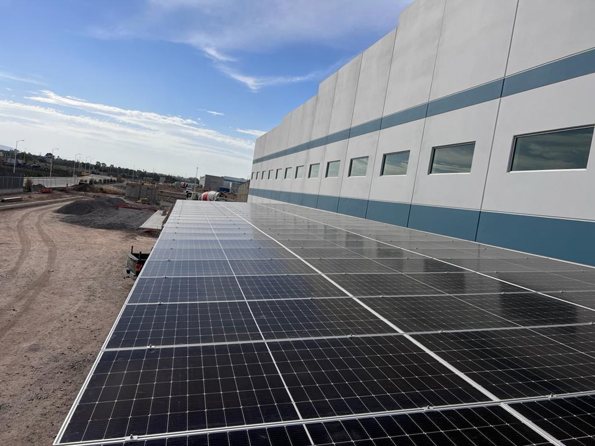 an abstract photo of a curved building with a blue sky in the background
