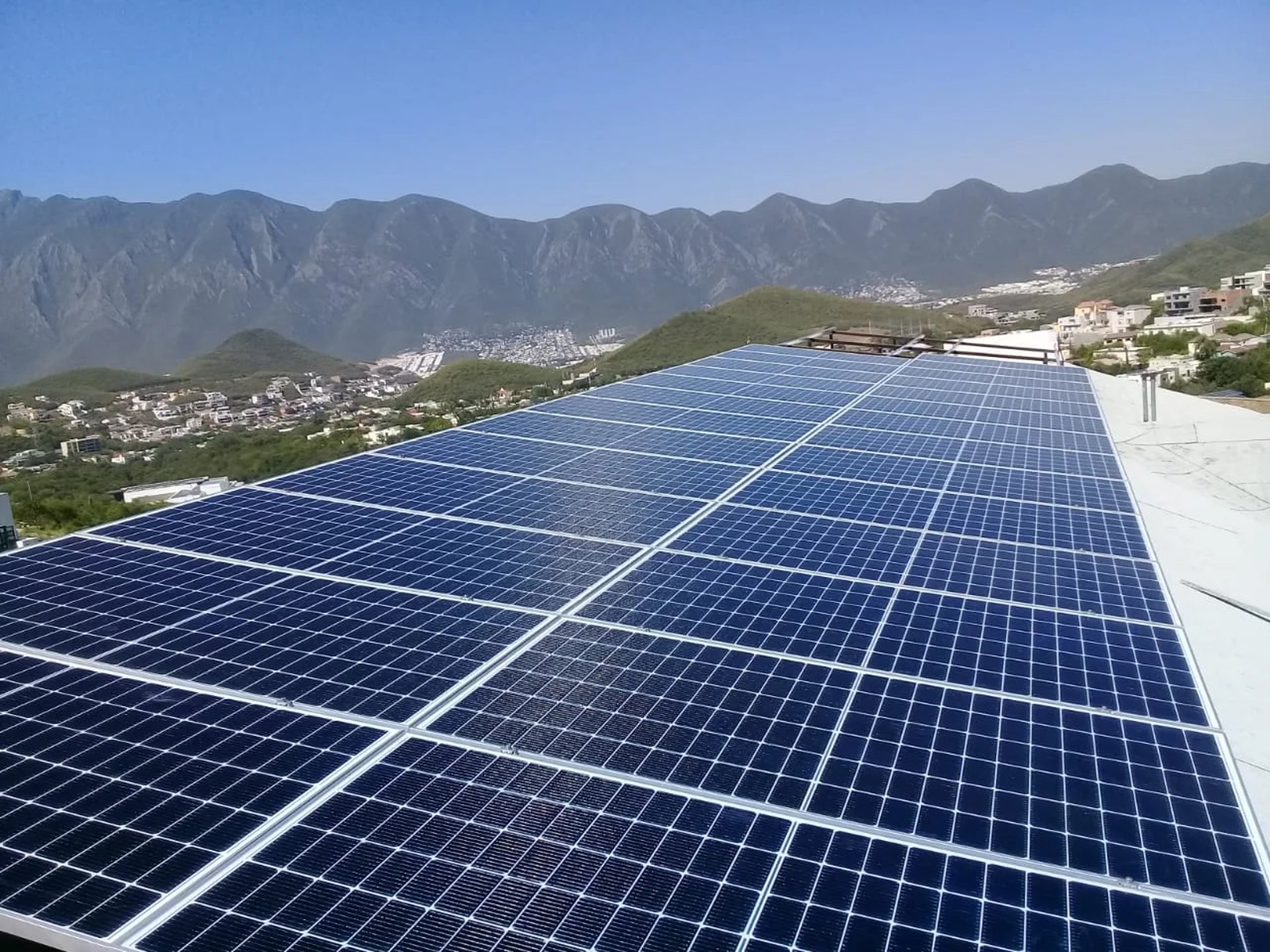 an abstract photo of a curved building with a blue sky in the background