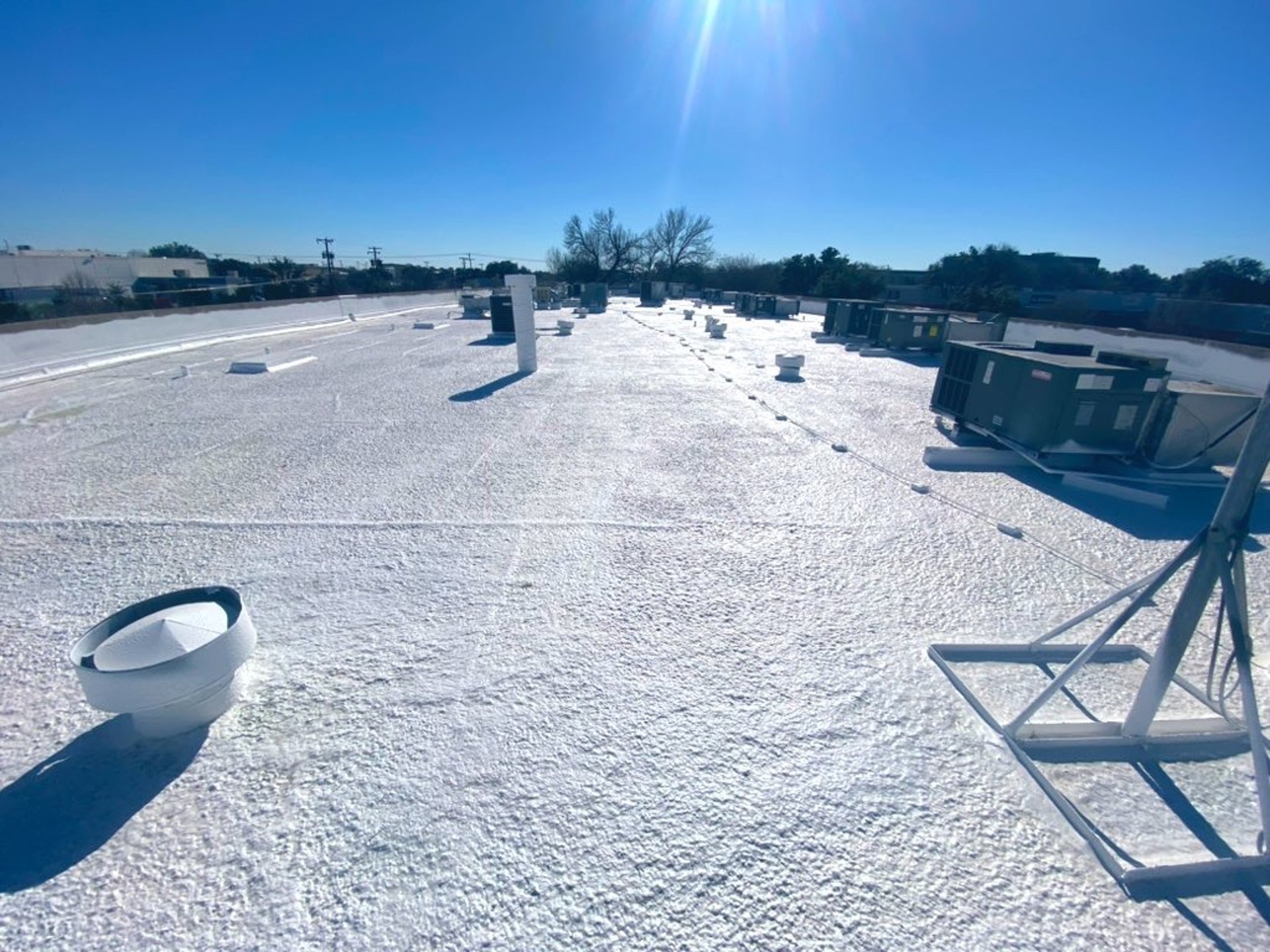 an abstract photo of a curved building with a blue sky in the background